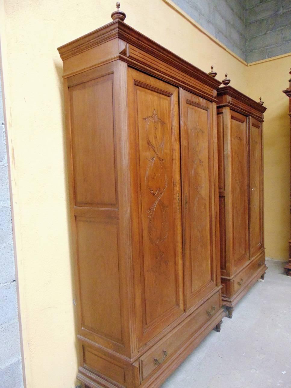A good matching pair of oak armoires of small size in the Henri II style circa 1900 each armoire having two hand-carved matching doors with a single full width drawer underneath. This price is for both items