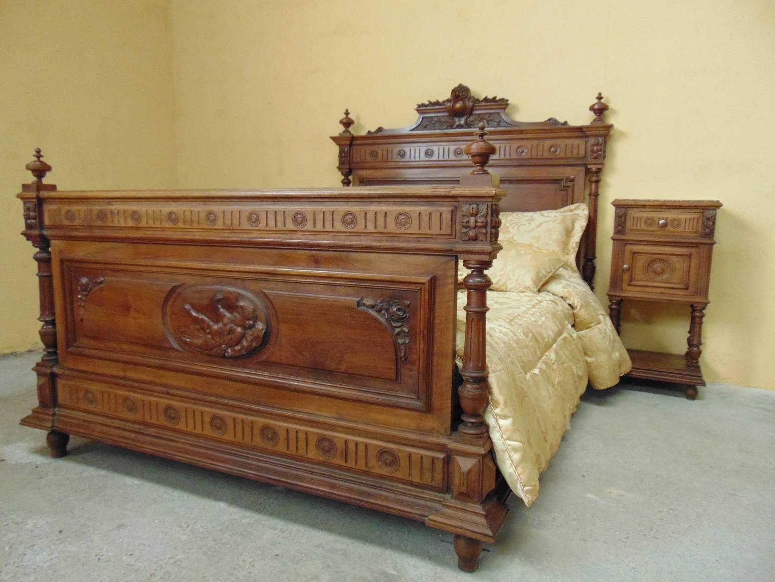 A fine and all original hand-carved double bed in the Louis XVI style circa 1890, depicting a Cherub on the footboard and profusely carved with foliage and geometric rondelles. Both the head and foot boards are flanked with turned and fluted columns