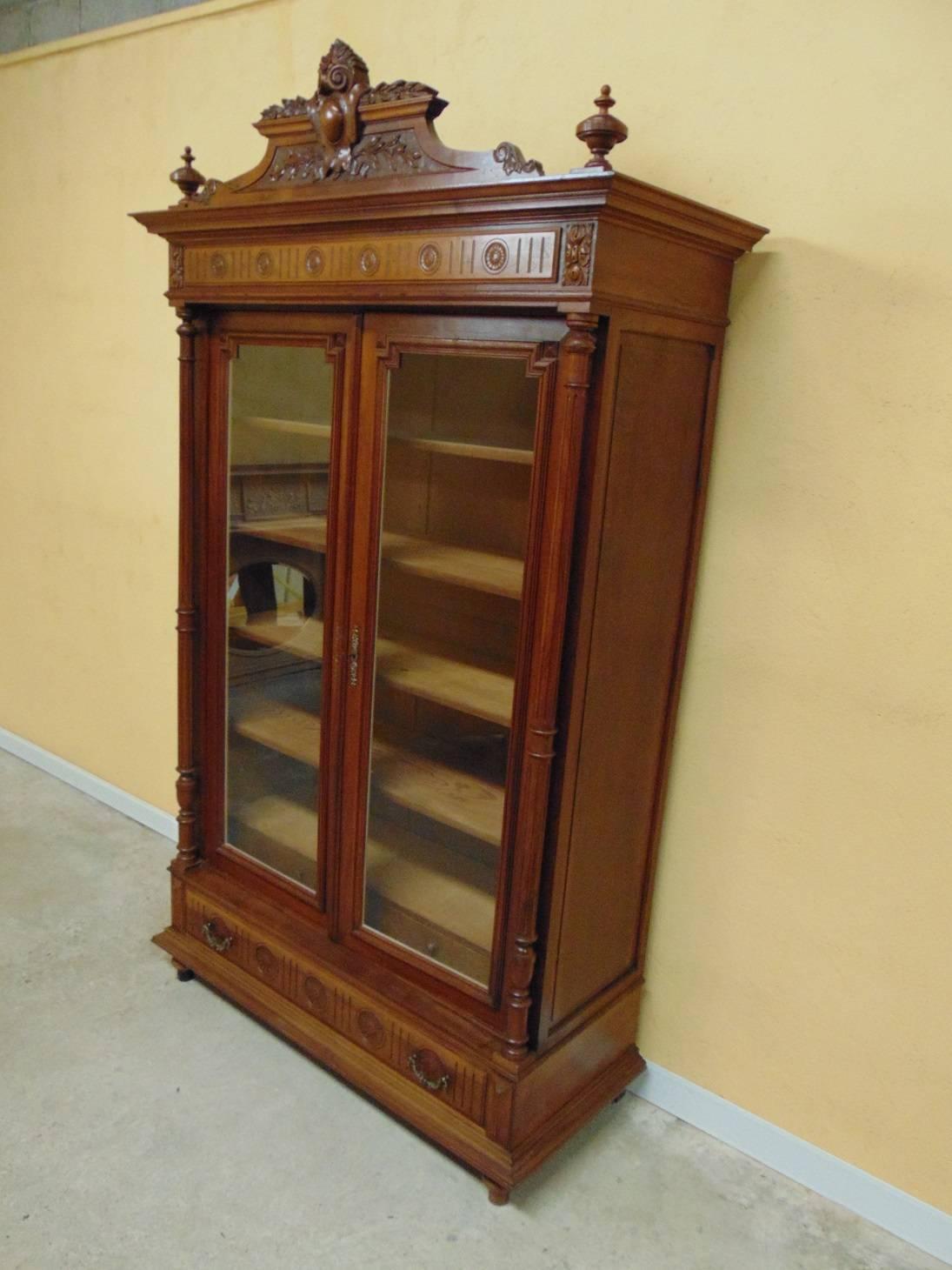 Beautiful solid Walnut Louis XVI style French two door bookcase hand carved and having fully adjustable shelves.  C1890 Disassembles completely by undoing just four bolts for moving and easy access to stairways and doorways.