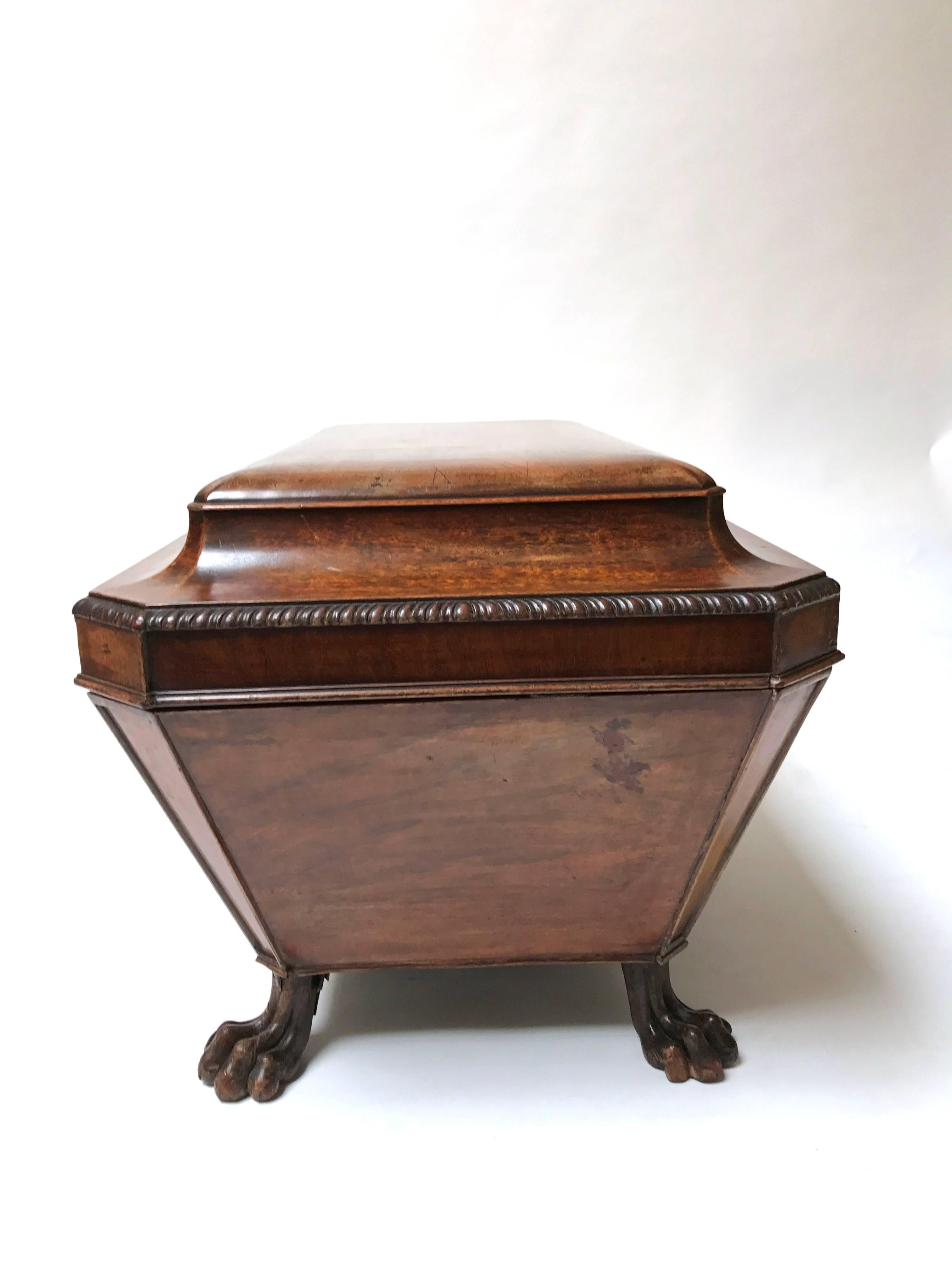 A late 18th century English Georgian mahogany sarcophagus flat-top cellarette of particularly elegant form, with claw feet and a wonderful faded warm mahogany patination, England, circa 1780.

Lovely for an end table or in front of a small sofa.