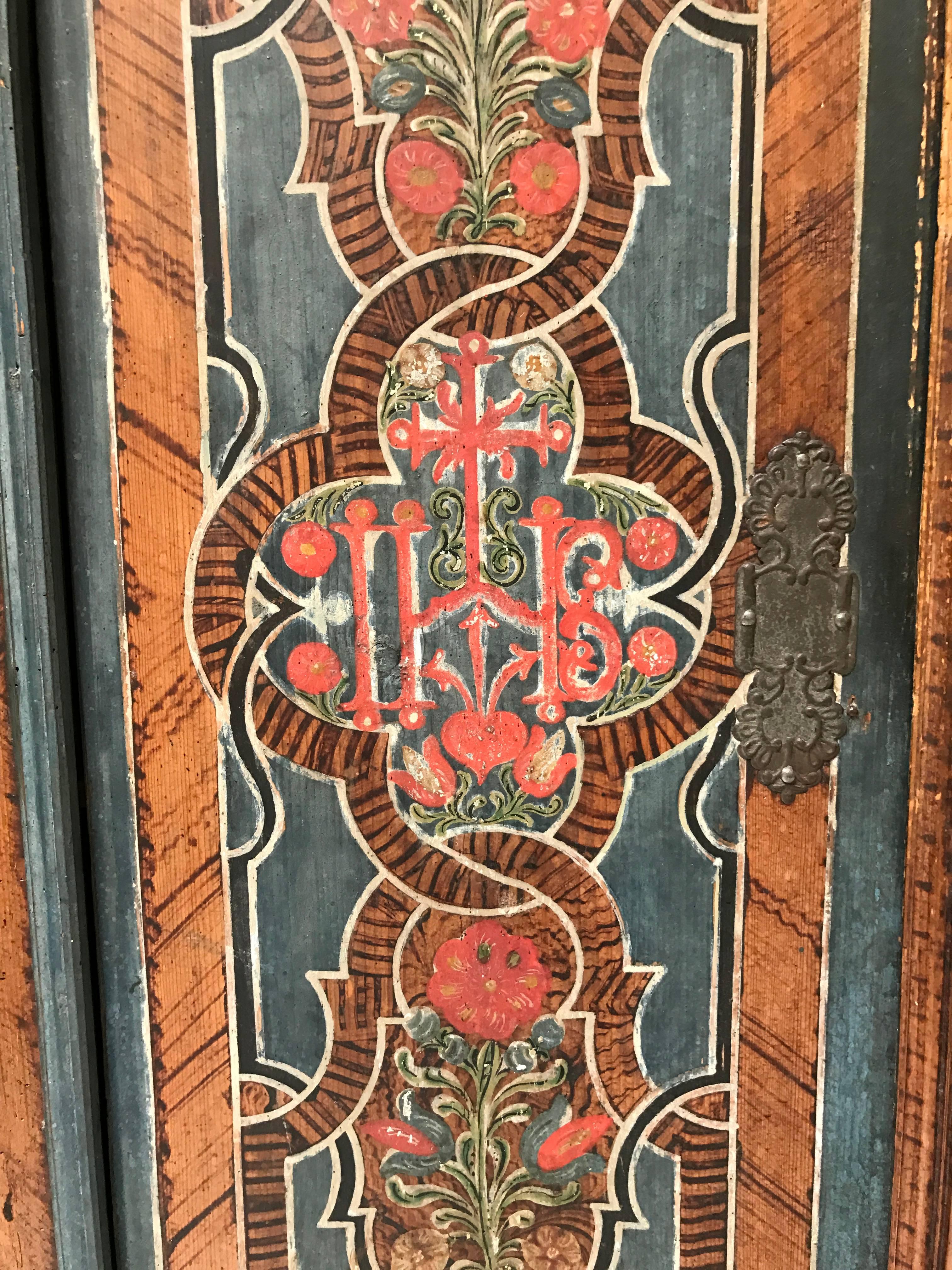 Highly decorative 18th century painted marriage armoire from Lithuania, with beautiful and intricate painting of flowers and geometric motifs, lovely patina, marked M and K at top of each door, 1786 date painted across top of two doors.