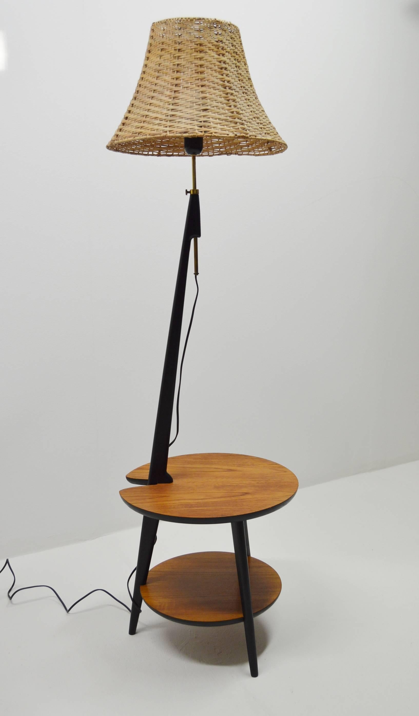 Rare table with built in lamp or contrariwise.
Teak table with minor marks. Lampshade of rattan. Base of black lacquered wood and brass fittings.

Produced in Scandinavia during the 1960s.
     