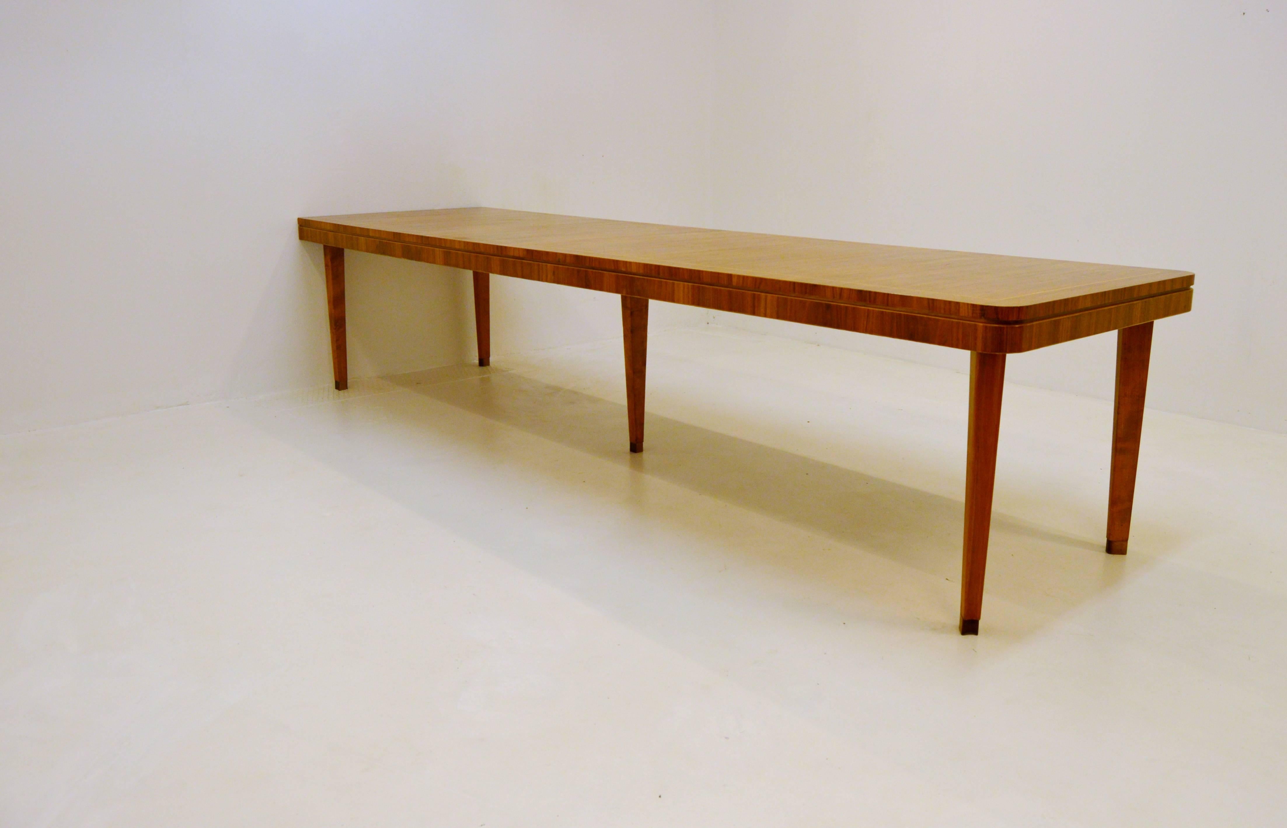Large dining or conference table of walnut, birch and mixed woods.

Most likely designed by Axel Larsson for Bodafors.

According to previous owner this table was ordered by a large company in Vetlanda, near Bodafors, for their board meeting