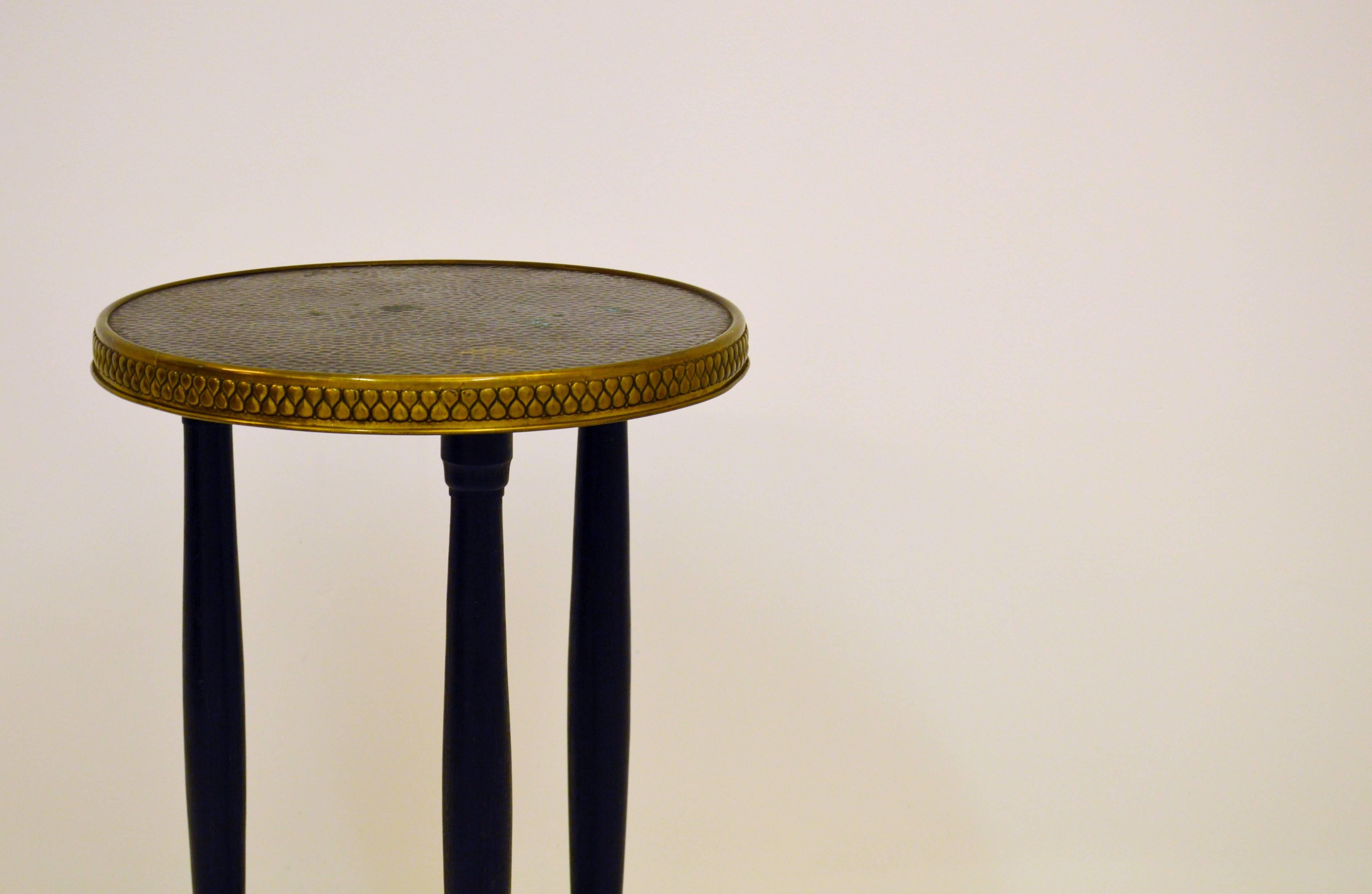 Small and easily placed side table. Stained wood and hammered top of copper with patterned brass edge,
circa 1930s.
