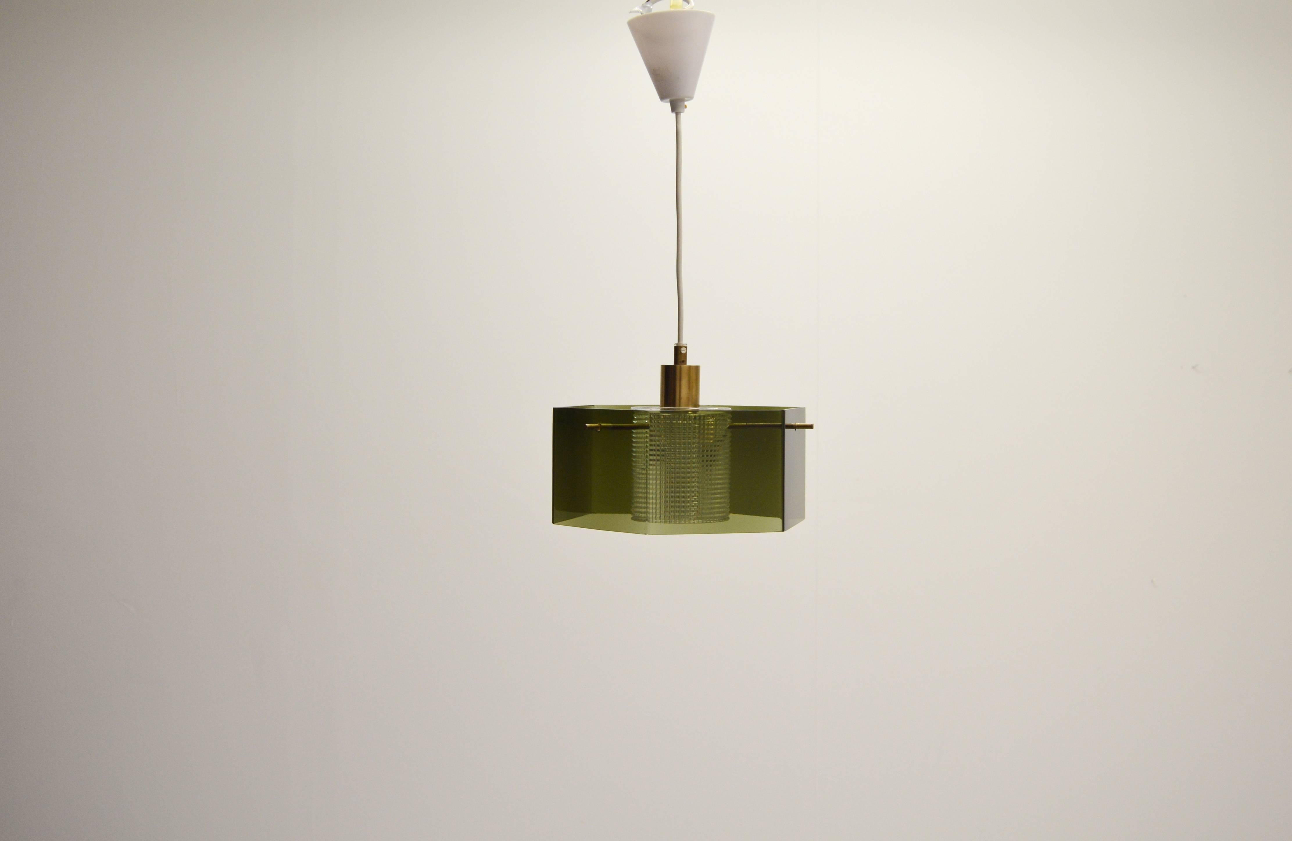Angular glass lamp designed by Carl Fagerlund for Orrefors, Sweden.
With brass details.
The cord gives adjustable height. Height below is given for the glass and metal parts.