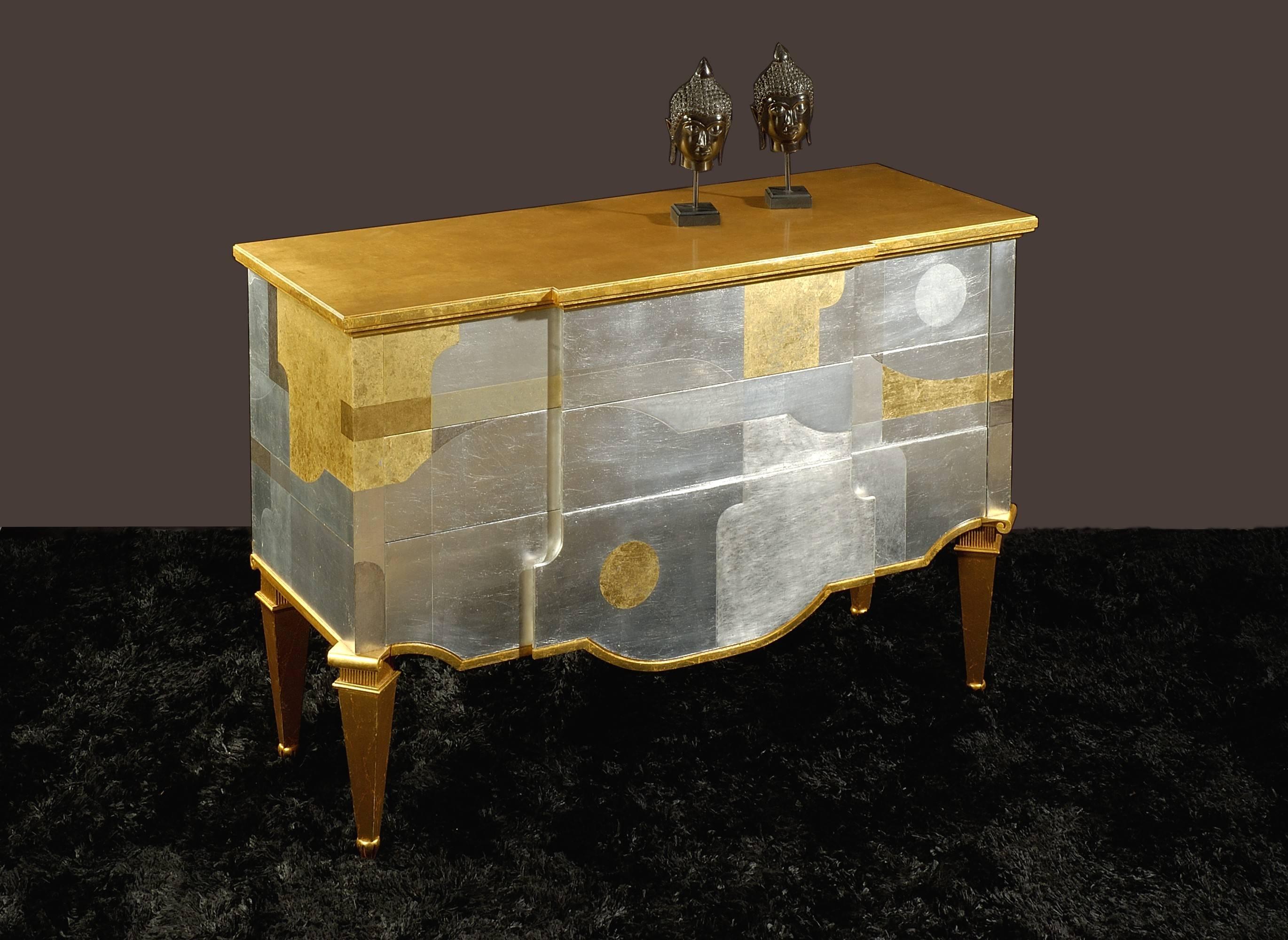 chest of drawers with contoured ddrawers and integrated handles. Structure in wood with gold and silver leaf mixed techniques decorations Doors. All the decorations are handmade.
  