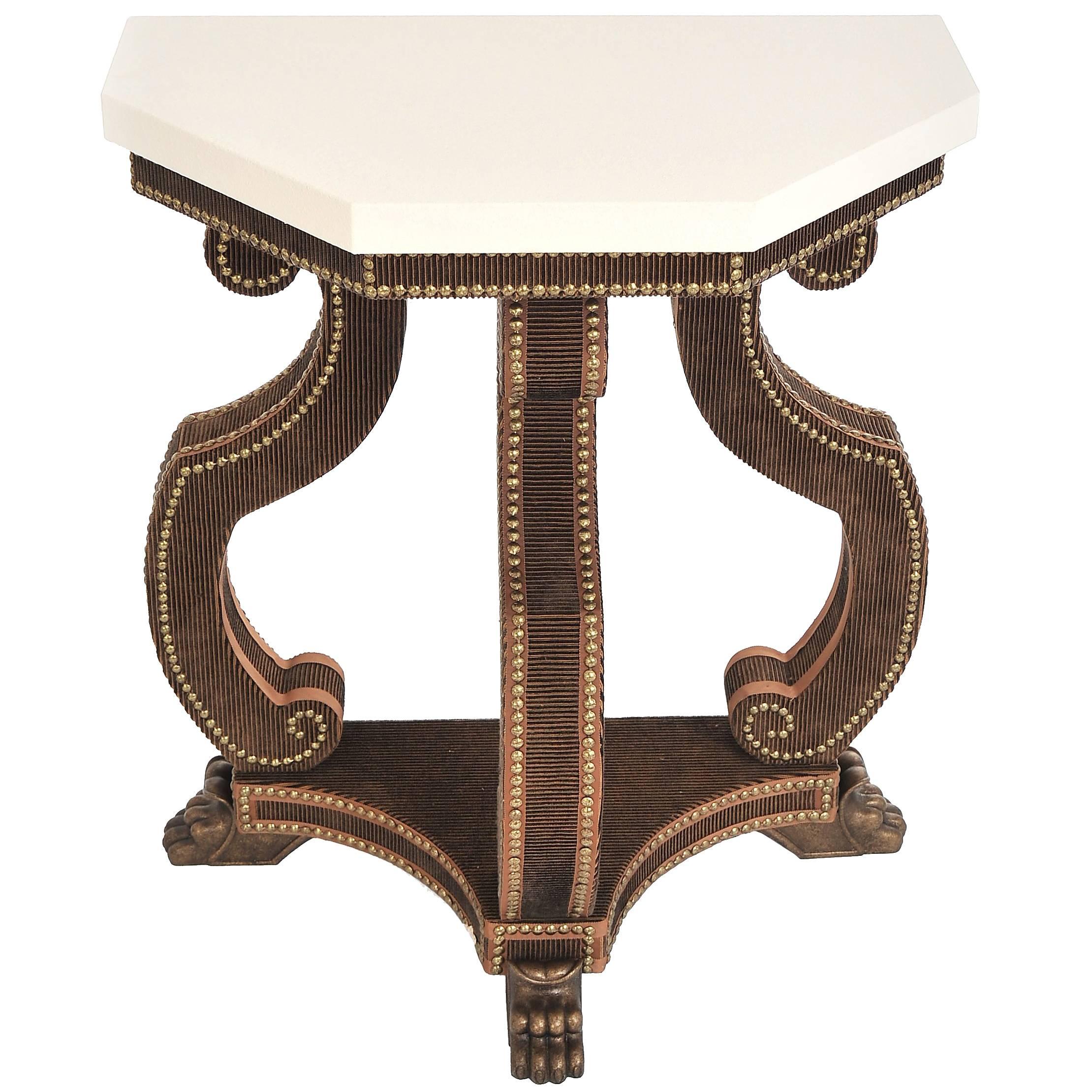 The Antonius demilune console table shown here in hand studded velvet with limestone top, is part of the velvet furniture collection designed by Alidad Ltd and Thomas Messel and based on Baroque and neoclassical shapes. It can be customized in a