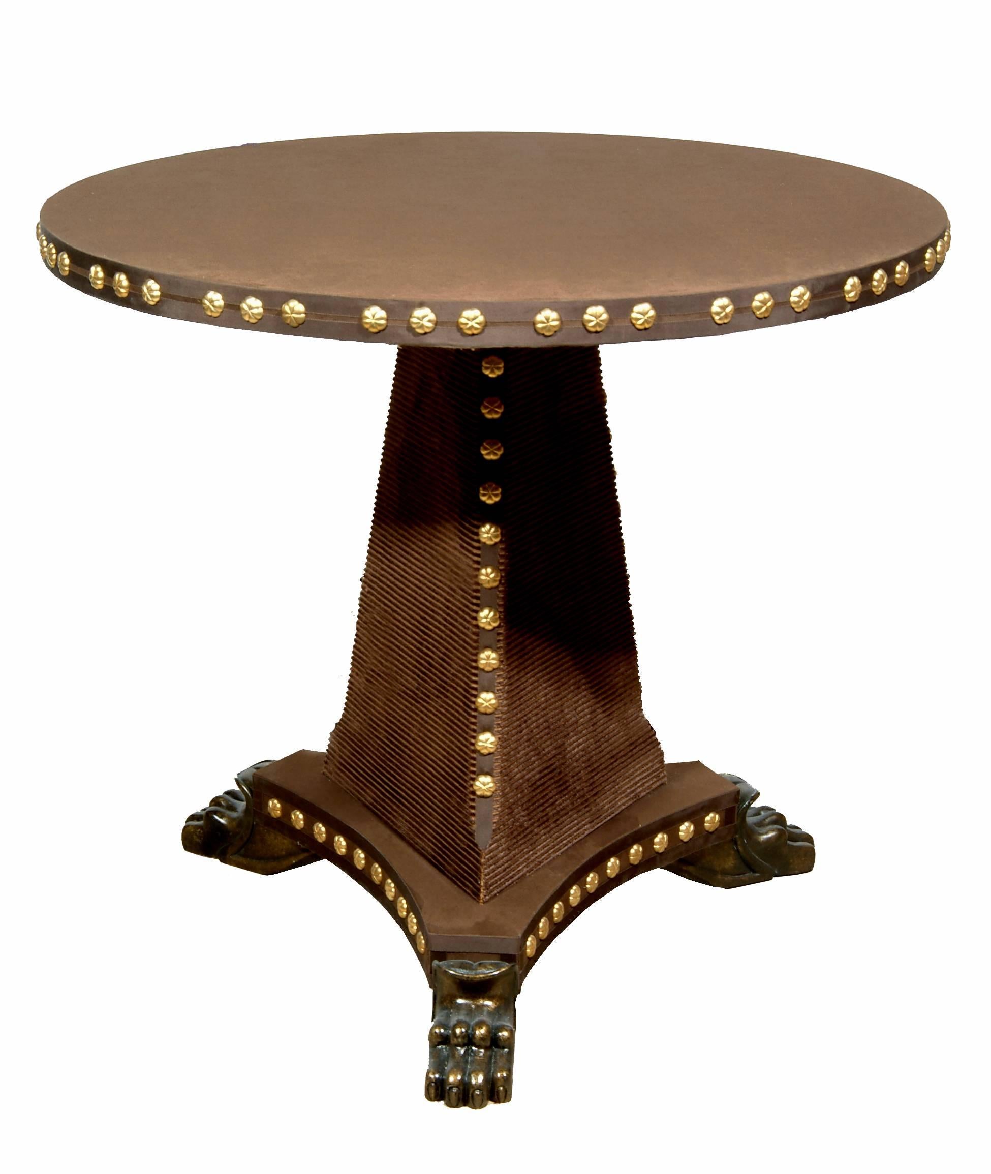 The Tiberius velvet covered centre table with tripod base shown here in studded red velvet and bronzed base, is part of the velvet furniture collection designed by Alidad Ltd and Thomas Messel and based on Baroque and neoclassical shapes. Can be