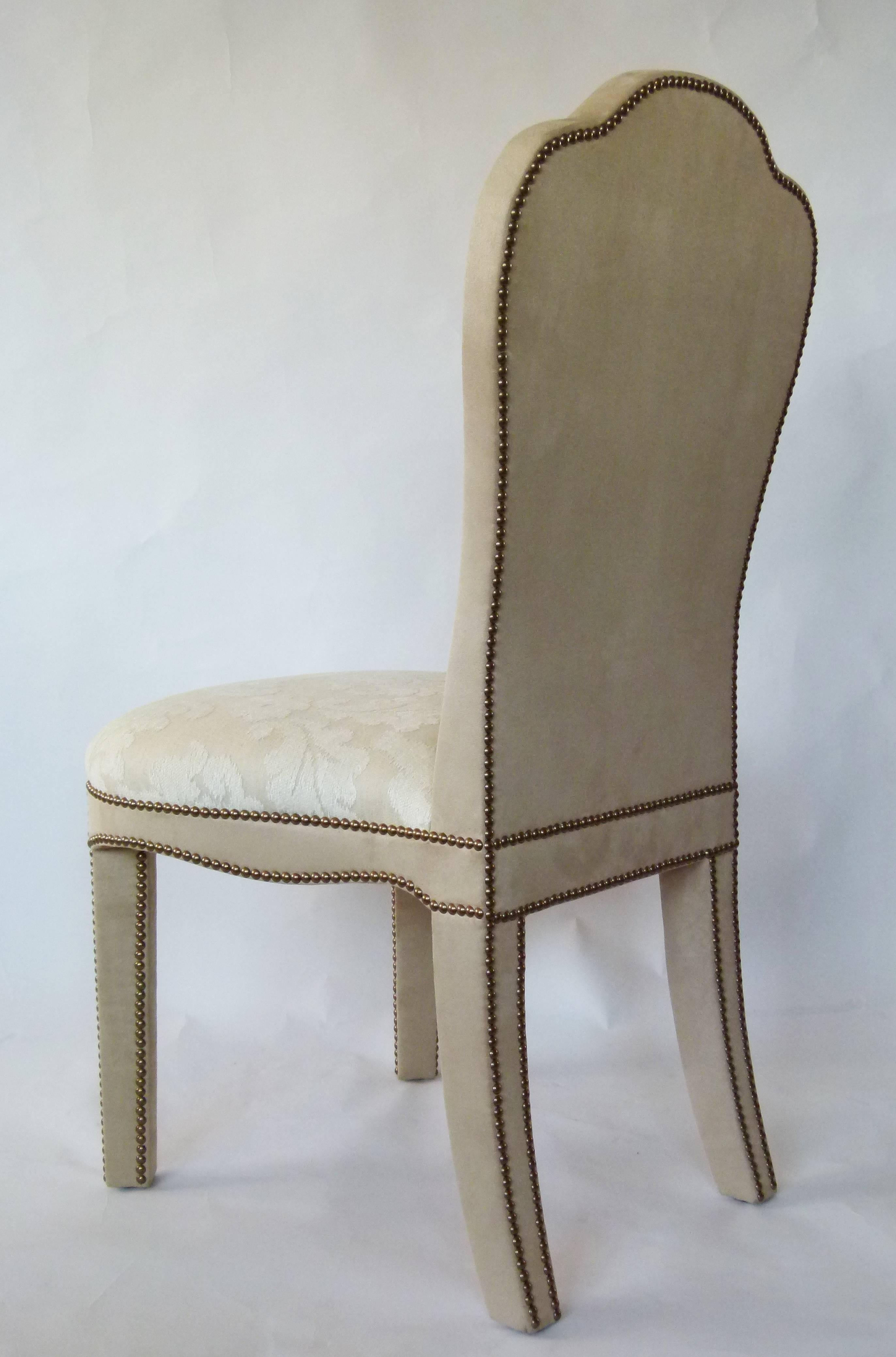 The Titus dining chair shown here in off-white Damask, contrasting faux suede and hand studded velvet is part of the velvet furniture collection designed by Alidad Ltd and Thomas Messel and based on Baroque and neoclassical shapes. The chair can be