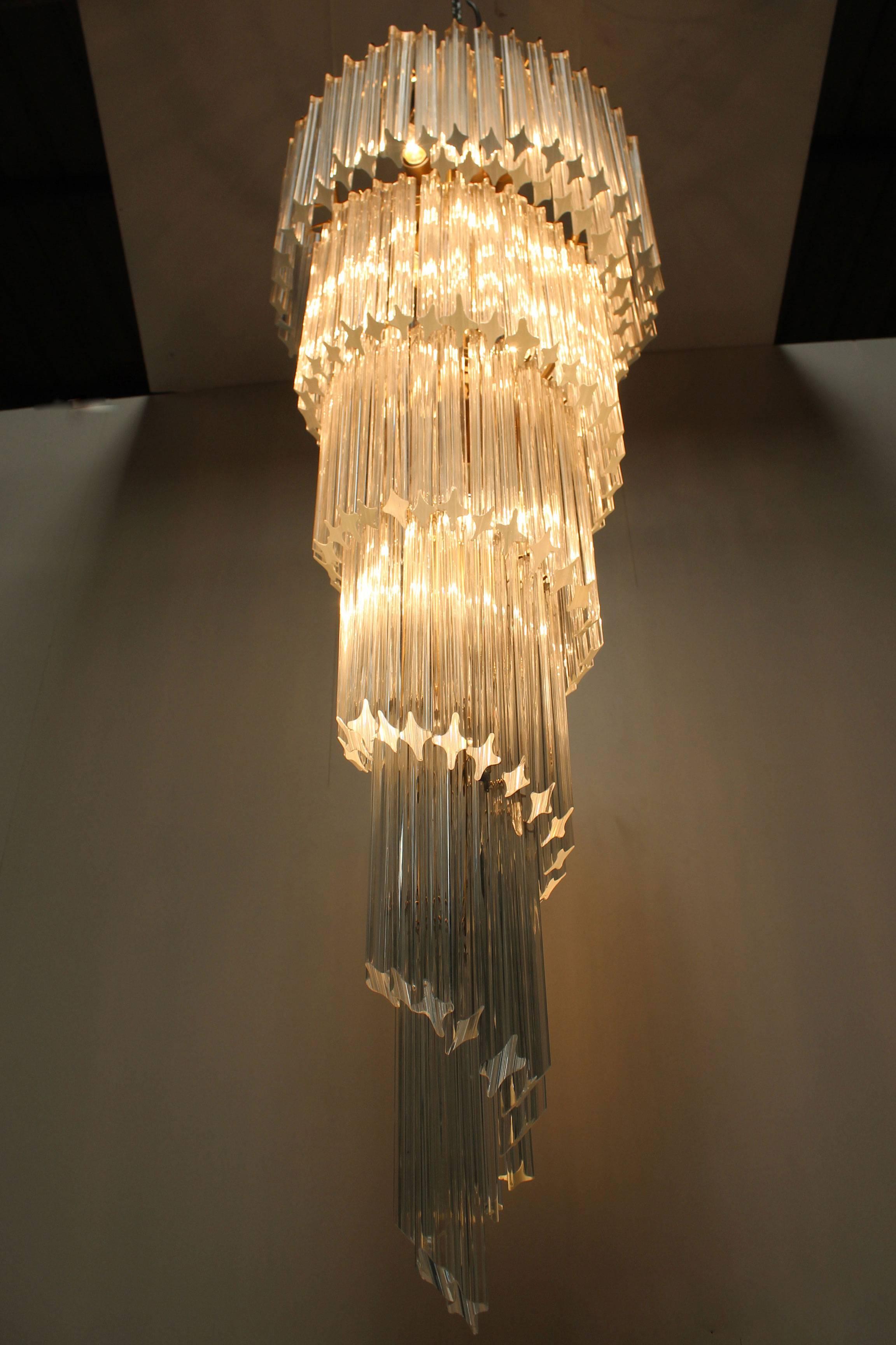 Large and stunning Italian Mid-Century crystal prism spiral chandelier by Paolo Venini, 1960. This large chandelier has a spiral shaped brass frame which is decorated with 166 handmade crystal glass prisms. The chandelier has 14 sockets and looks