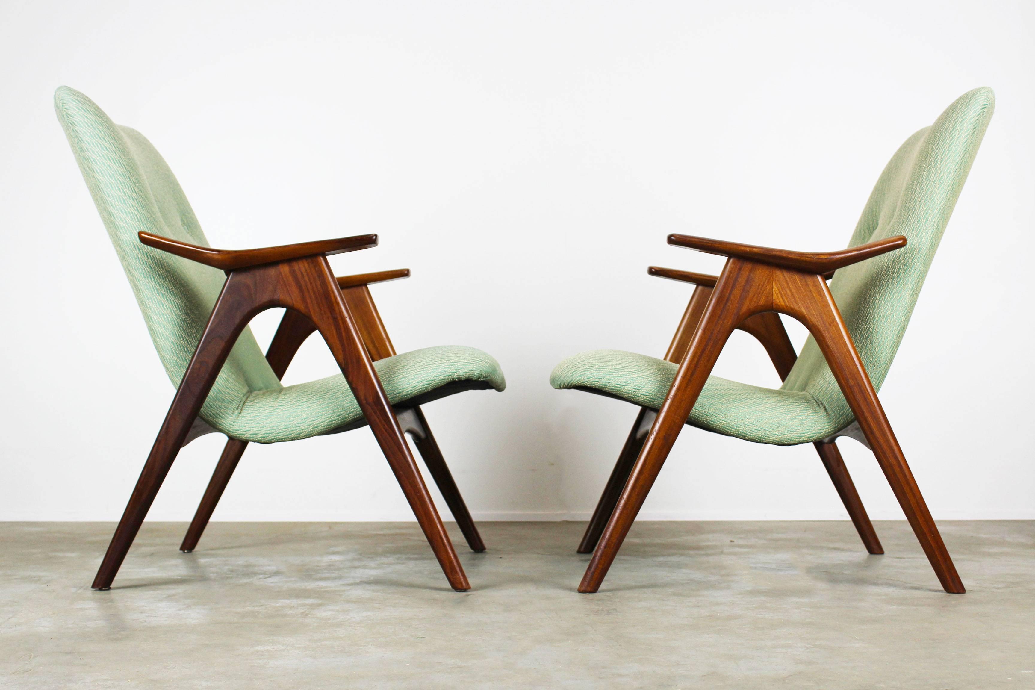 A lovely pair of two Lounge chairs designed by Louis Van Teeffelen for Webe in 1960. The chairs have a stunning organic shaped solid teak frame and have their original 1960 upholstery. Wonderful woven fabric with white trims and mint green. Very