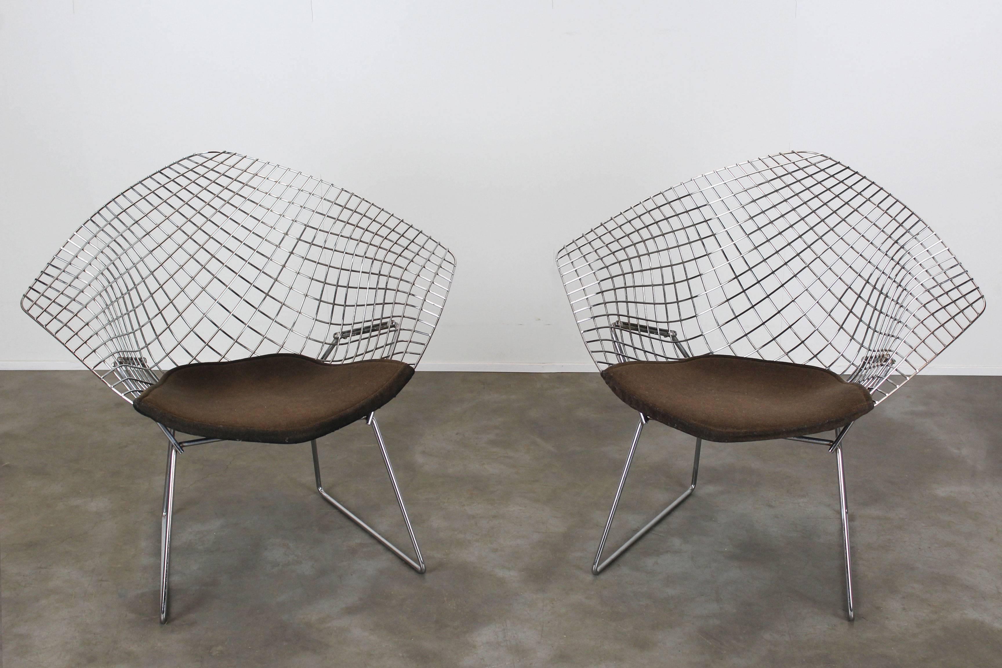 Set of two chrome diamond chairs by Harry Bertoia for Knoll with grey/brown cushions. 
Slight sings of use on the cushions, chrome in great shape.