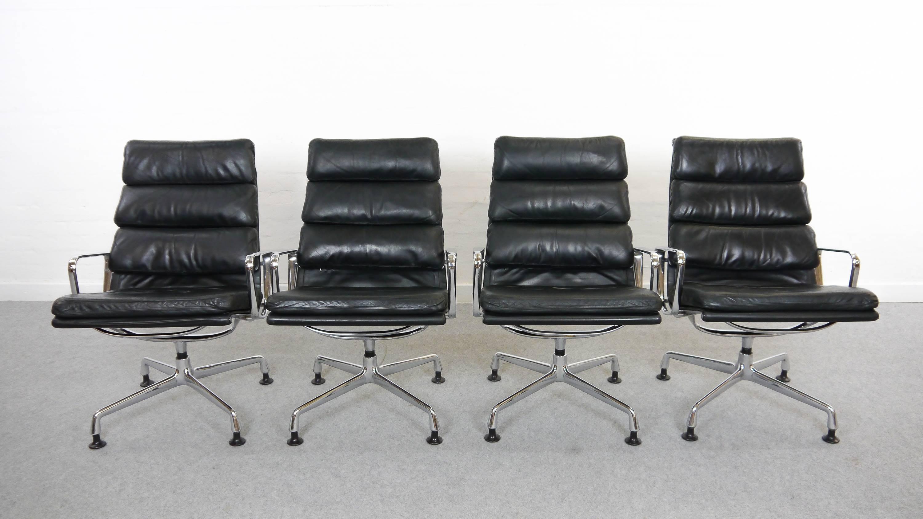 Vintage set of four easy chairs EA 216 soft pad. Manufactured by Herman Miller / Fehlbaum, Germany. Original black leather upholstery. Embossed Herman Miller Logo. One chair has a rest-label of the early Miller Logo. These swivel-chairs are very