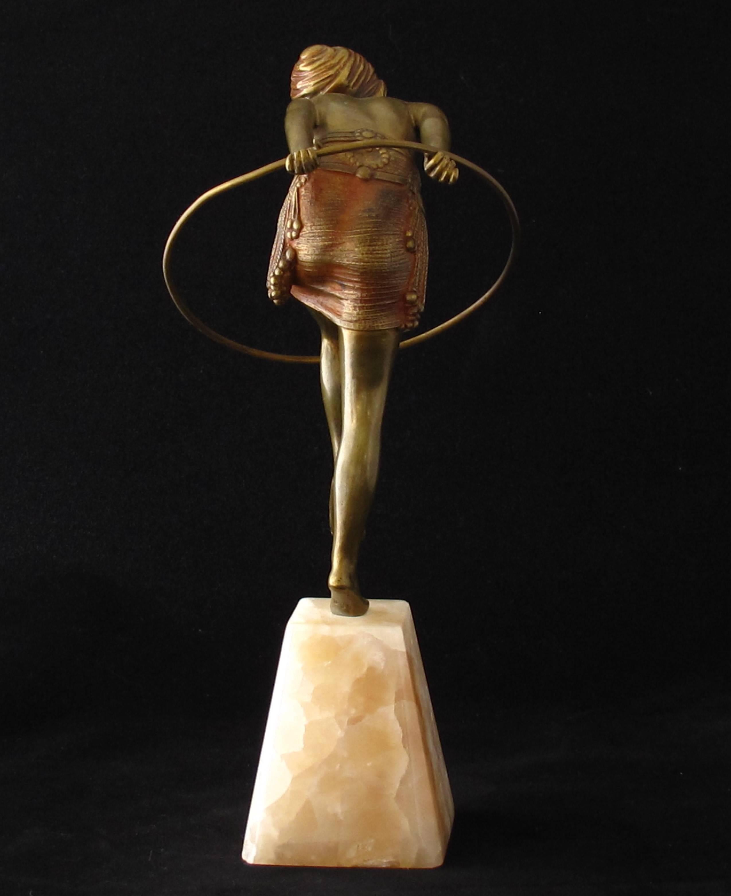 Art Deco bronze figure of a dancer with hoop. Gilt and cold painted with her arms outstretched behind her, stepping through a hoop. Signed Chiparus in the marble base. Approx height 25 cm. French c 1925 - Excellent original condition. A similar