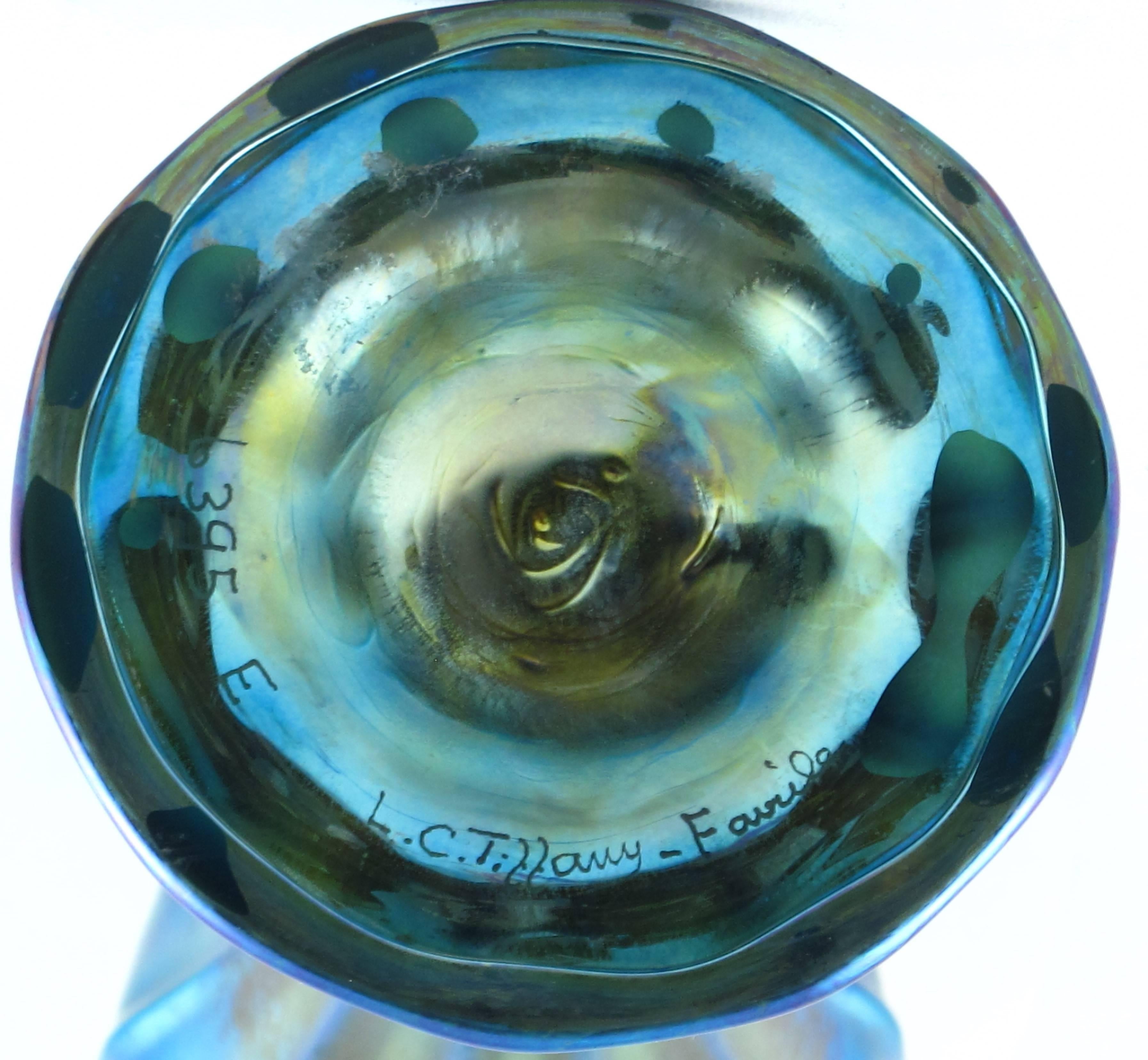 Art Nouveau stunning Tiffany Favrile footed stemmed Floriform vase in a stunning iridescent blue. Approximate 23.5 cm tall and base 9 cm diameter. Signed to the underside 6395 LC Tiffany Favrile. Produced, circa 1900. Excellent original