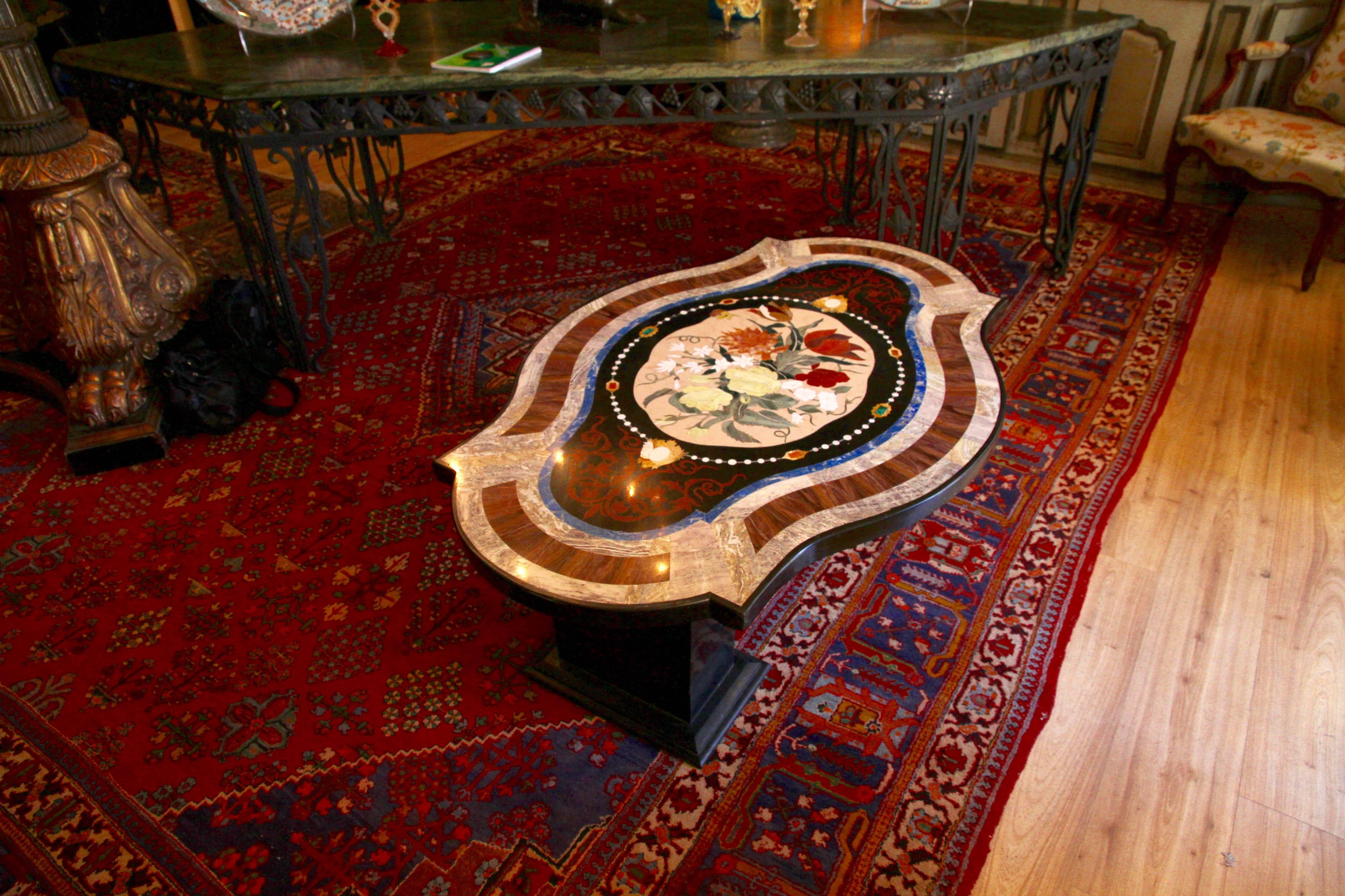 Coffee table in Pietre dure marquetery with a slightly lively shape using different semi-precious stones such as malachite, lapis lazuli, black Belgium marble, red jasper, chalcedony, yellow Sienna marble, white agate, cornelian, pink Portuguese