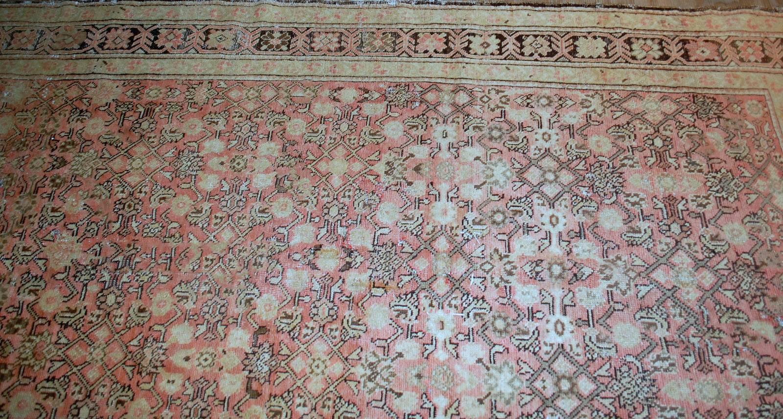 Antique handmade Caucasian Karabagh rug in good condition. This rug made in peach shade with all-over design. Very busy tribal ornaments in chocolate brown shade are decorating this rug. The border is in similar shade of brown and decorated in