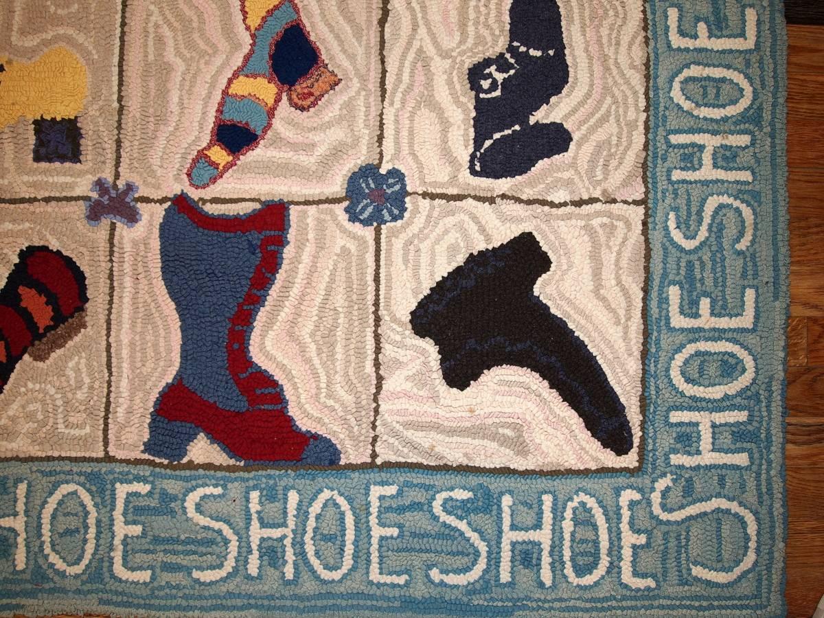Handmade vintage American hooked rug in original condition. This magnificent rug was made in 1950-1960 in a modern style on that time. The beautiful peach background covered with different sort of shoes all over the rug in different shapes and