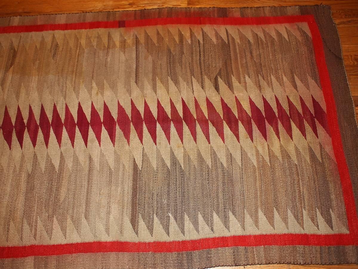 Antique handwoven American-Indian Navajo rug in original great condition. This collectible rug has very nice size for Navajo type. Traditional tribal patter in grey and red shades. Some colors a little bit bleeding. The rug is in original condition