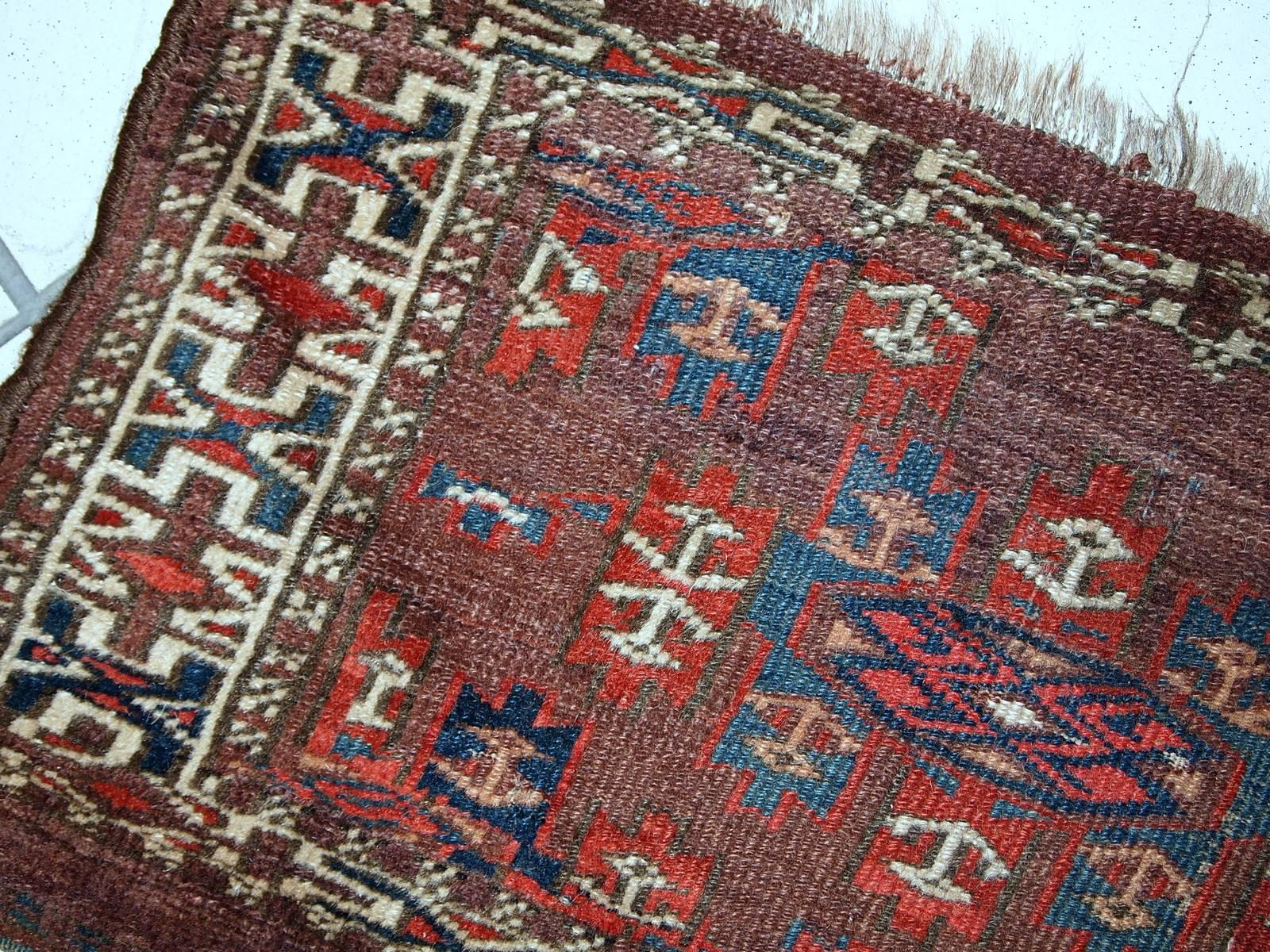 Handmade antique collectible Turkoman Yomud rug in deep burgundy color with Classic design. Little anchors in brown and beige shades are spread around the rug randomly. Beige and navy blue shades represents some tribal design on it. Beige border