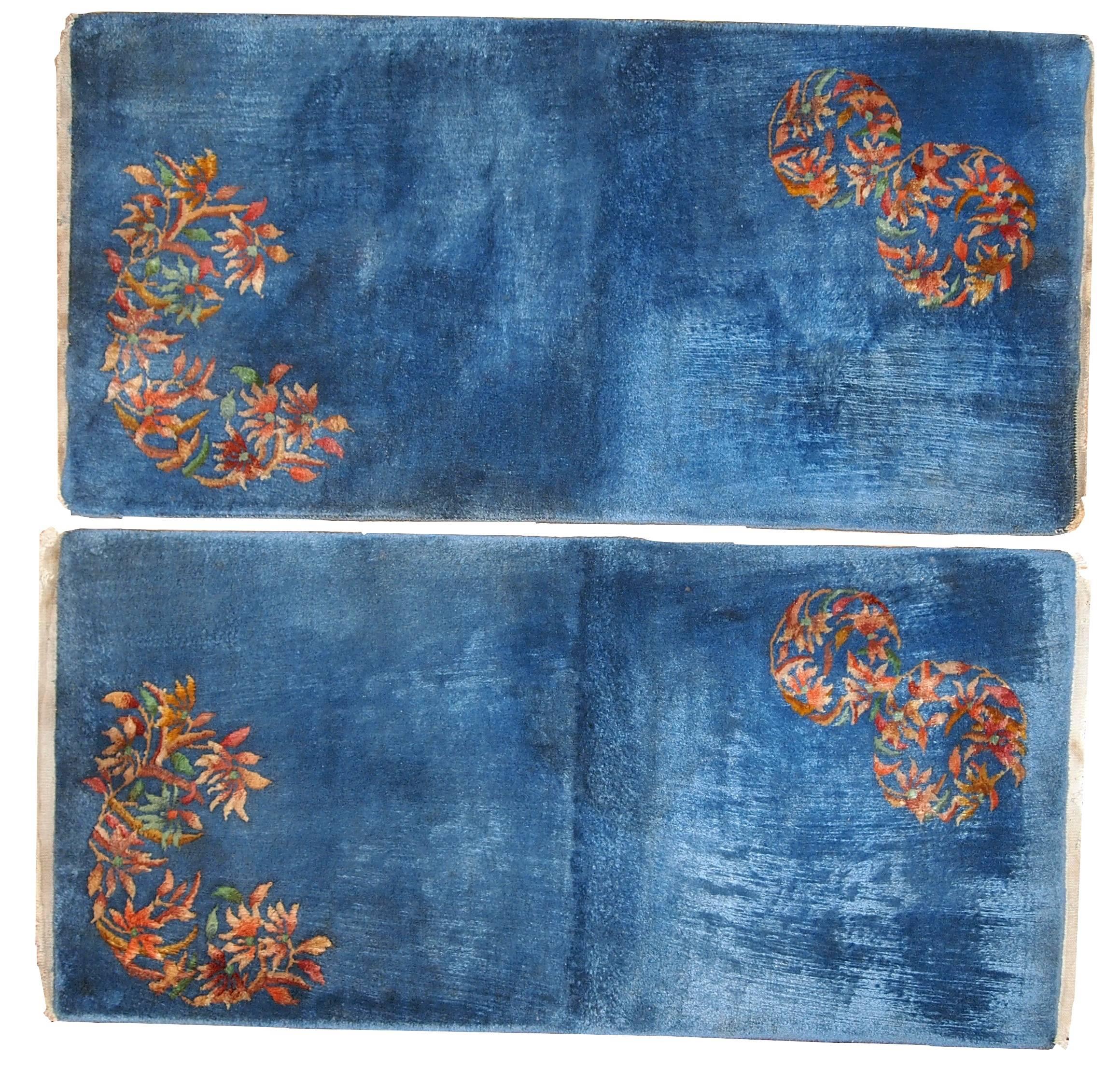 Handmade antique Art Deco Chinese pair of rugs in sky blue color and minimal floral design in the corners of the rug. The colors are very shiny, depends from which side you are looking at the rug. Wool is very soft and pleasant to walk on. The blue