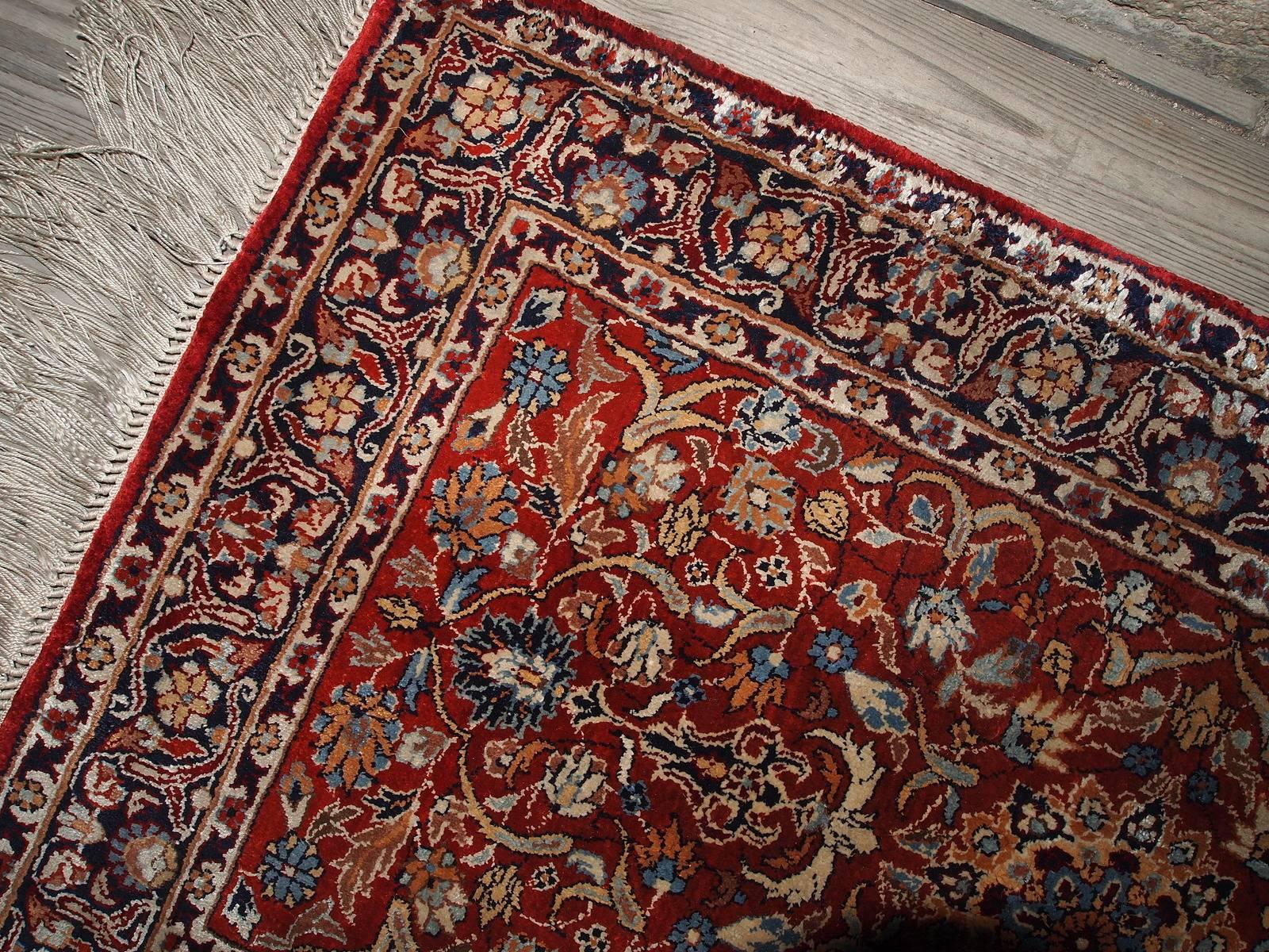 Handmade vintage Indian Qum rug. This rug was made out of silk in amazing bright colors of red, beige and navy blue. It has garden design, highly detailed foliage and flowers spread out all around the carpet. It was made from the silk and can shine
