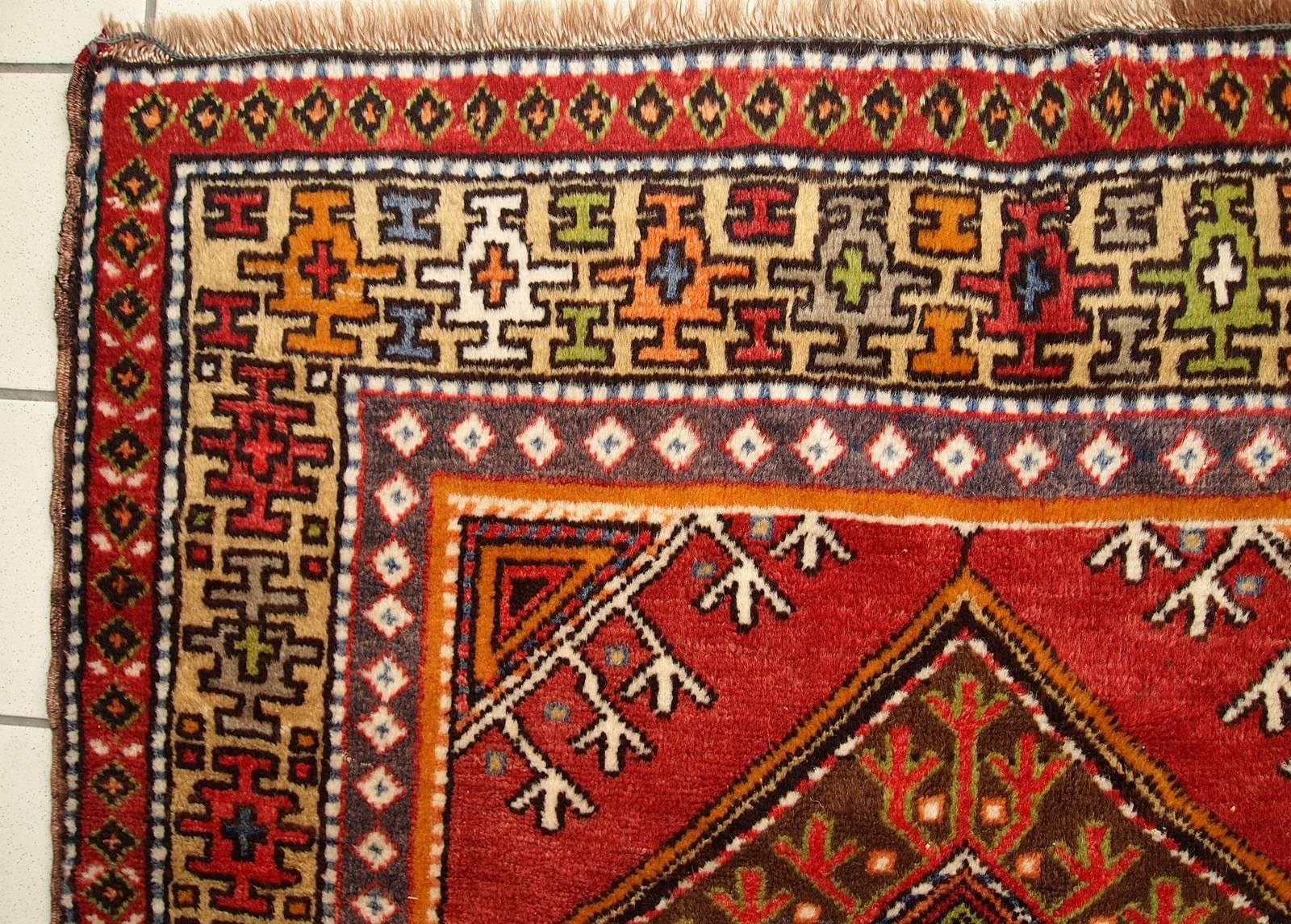 Antique Turkish Anatolian rug in original condition. Beautiful red filed with three diamond shaped medallions in brown color. The yellow border is covered in geometric colorful ornaments. Wool is very soft on this rug. The pile is full, no stains or