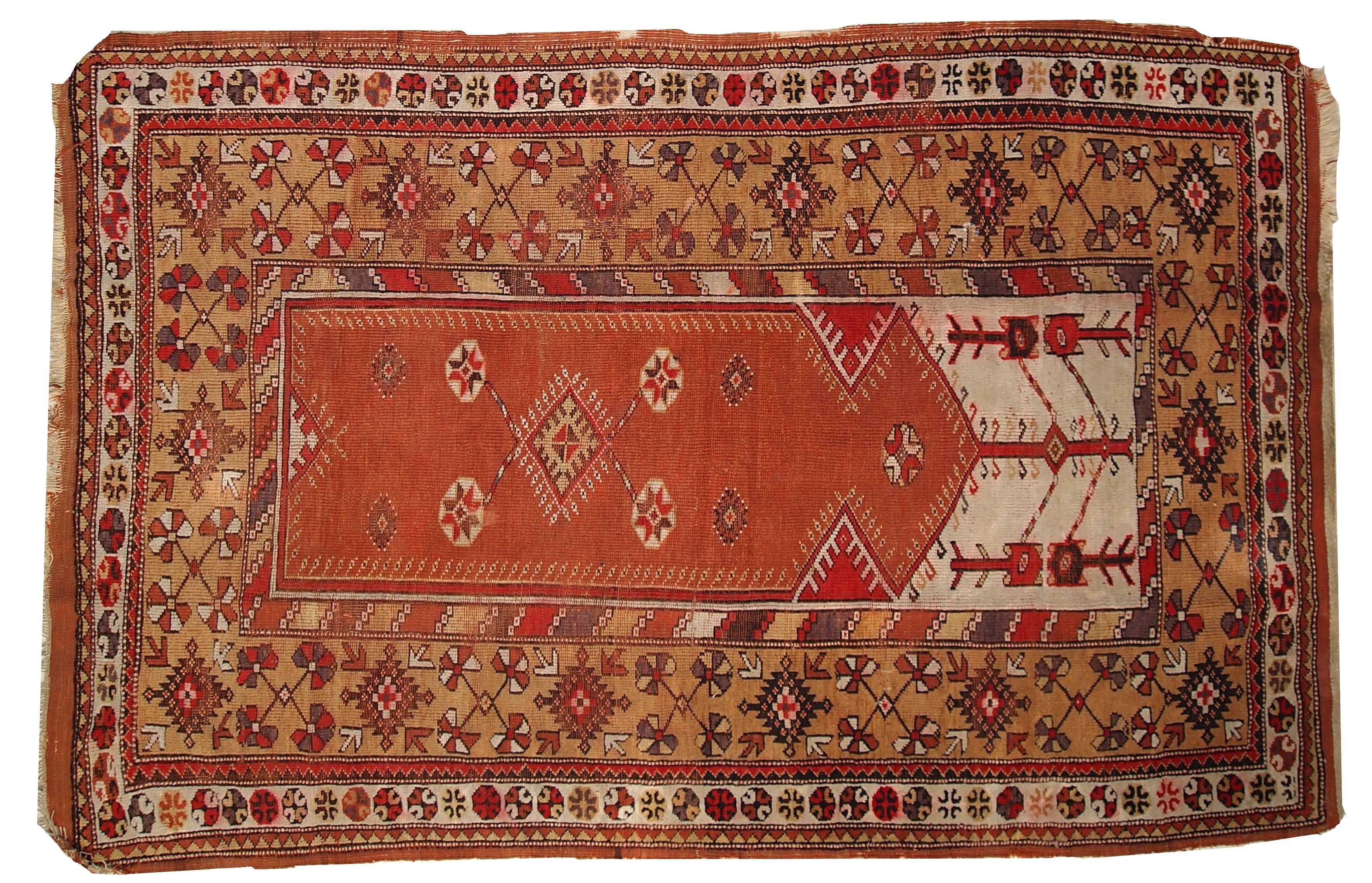Handmade antique Turkish Melas rug from the beginning of 20th century. The rug is made in traditional Melas praying style in regular for it colors: red, white and yellow. It has beautiful large border surrounding central praying area. The condition