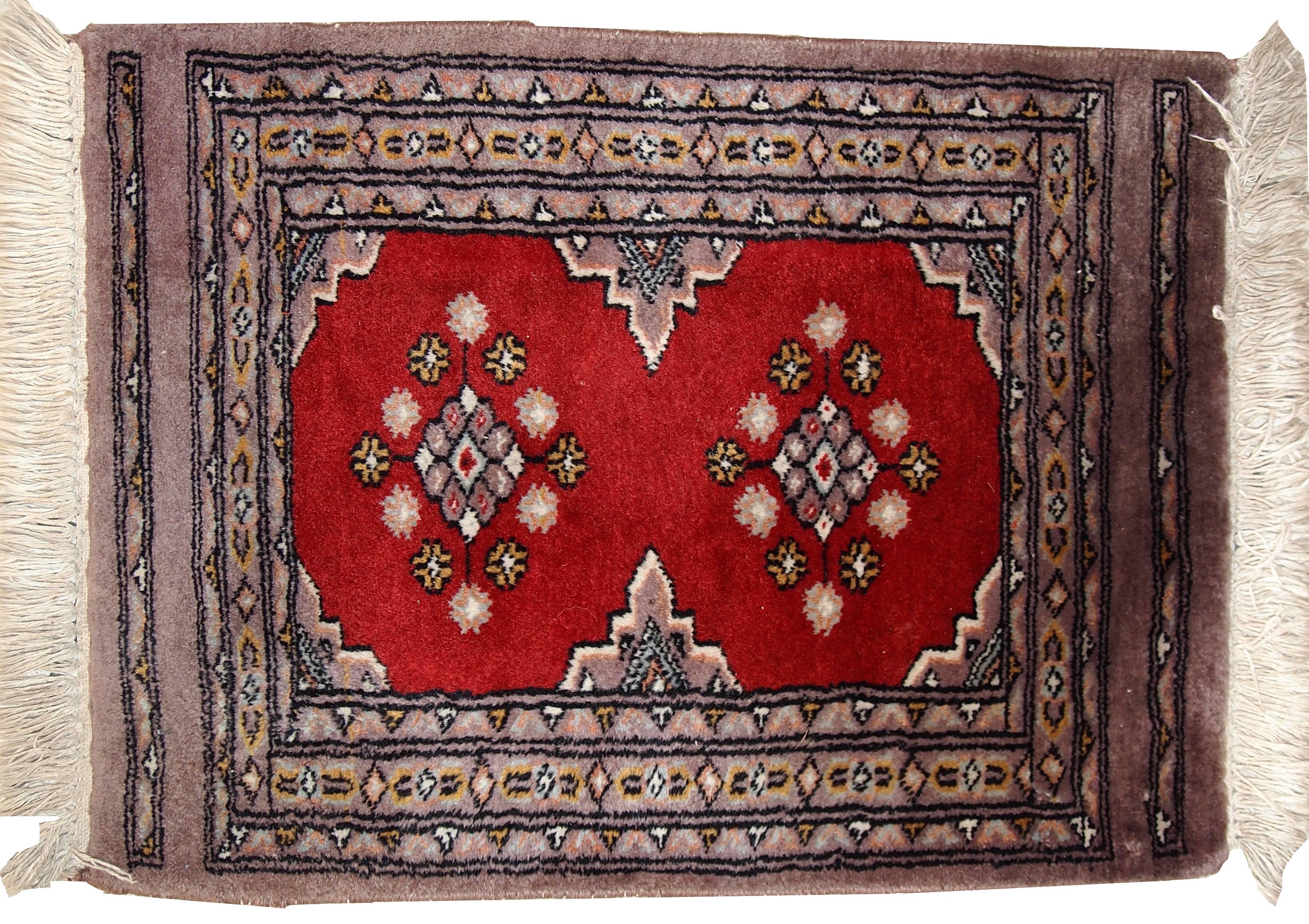 Vintage handmade Uzbek Bukhara rug in original condition. The rug made in bright red color for the field with two medallions in the centre Border side made in burgundy color with tribal miniature design on it. The condition of the rug is good and