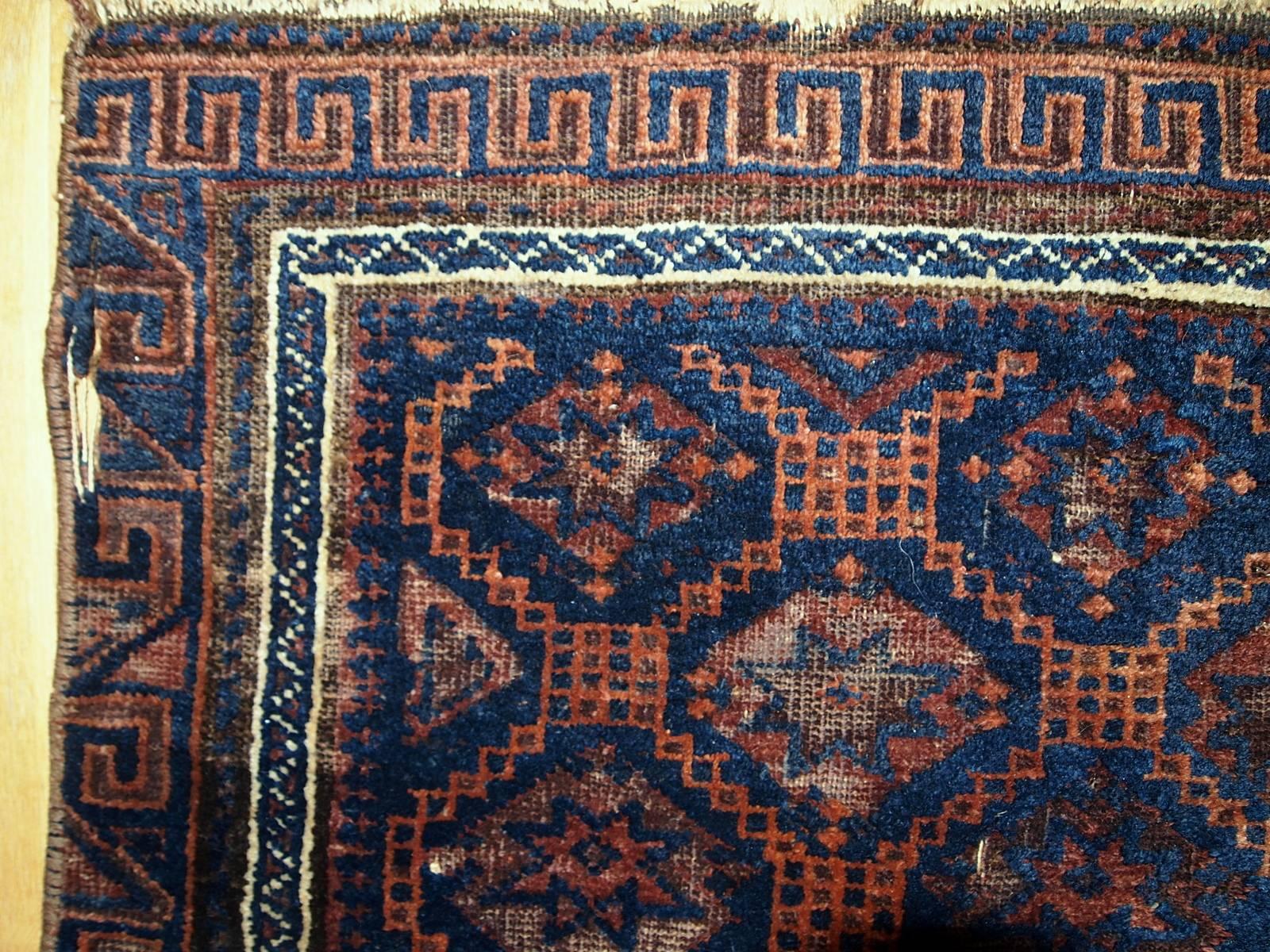 Antique handmade Afghan Baluch bag face. The rug has geometric pattern in diamond shaped figures with eight corners stars inside. Very unusual and nice border with geometric design as well. The combination of colors is lovely: night blue with rust