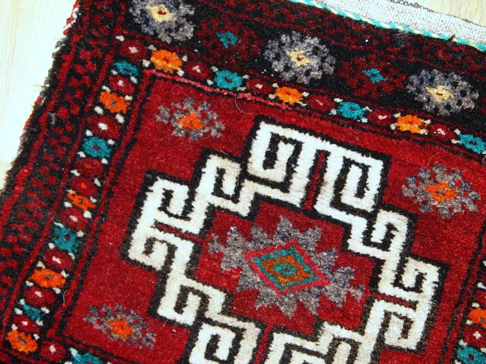 Handmade Turkish Anatolian bag in original condition. This bag has very deep colors from the front side of it- deep red for the field with some turquoise and orange details. The back side made out of stripped Kilim in red, gray and blue shades. The