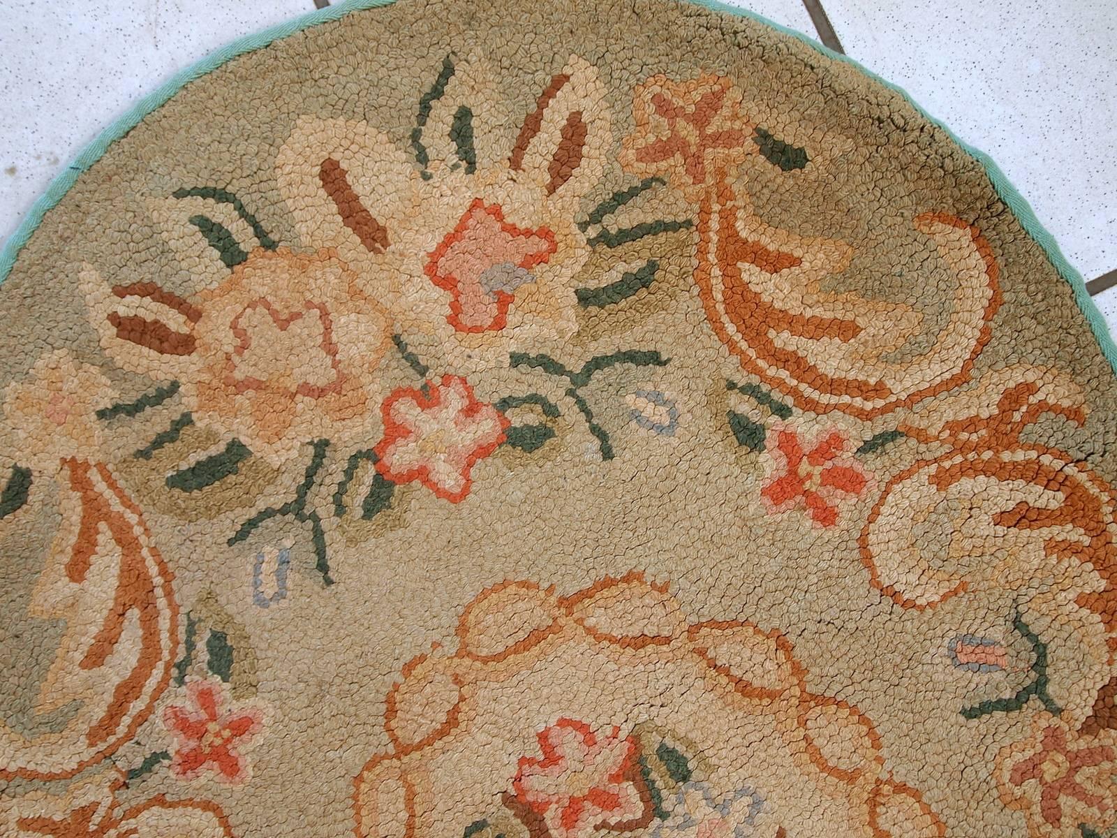 Handmade antique oval American hooked rug in original condition. The rug made in typical floral design for 1930-1940s, in light green shades. Beautiful colors and French style design. The rug is in original good condition.
 