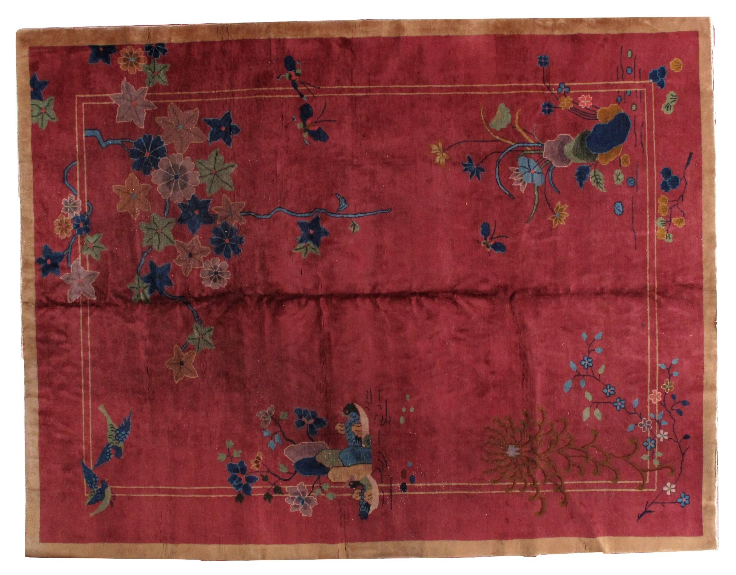 Antique Art Deco Chinese rug in original condition. The rug is in scarlet color with some red shade on it. The rug has beautiful decorative design mixed with floral. There some birds and butterflies imaged on the rug. Dominating colors on the rug: