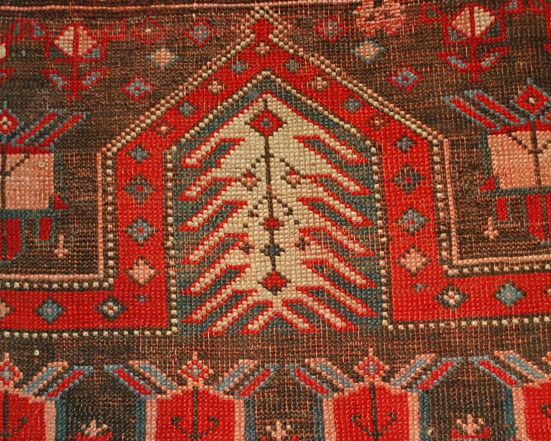 Antique handmade Russian Karabagh runner in original condition. The rug is prayer. The chocolate brown colored field decorated with bright red tribal ornaments. Pointing area is in tribal accent as well. The border is in bright red shade with