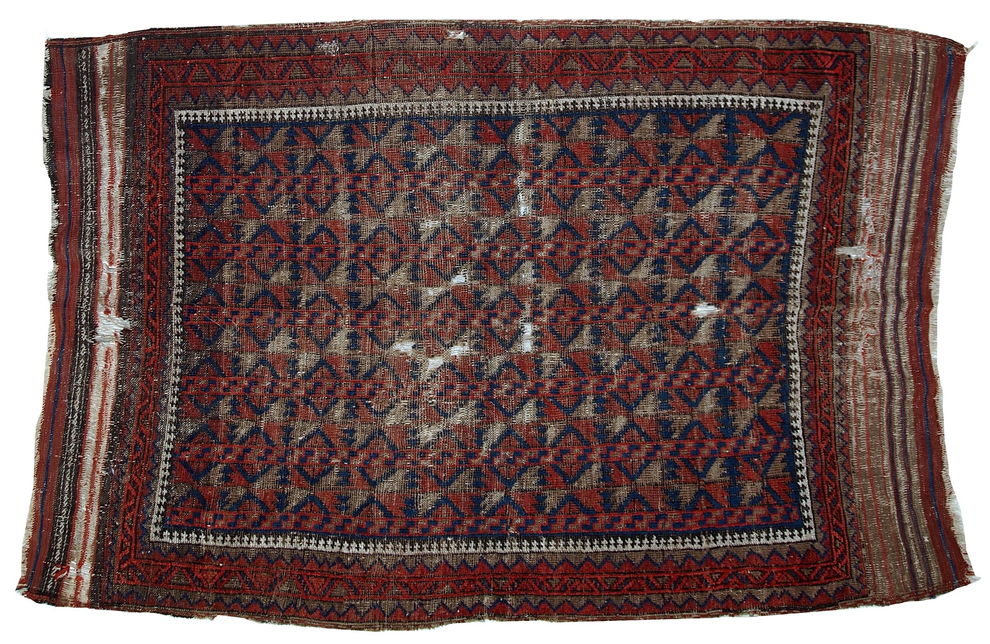 Antique handmade Afghan Baluch rug. The background contains two main shades: navy blue and deep burgundy. Repeating diamond shaped background. Nice tribal border surrounding the central area. The rug is from the end of 19th century? It is very thin
