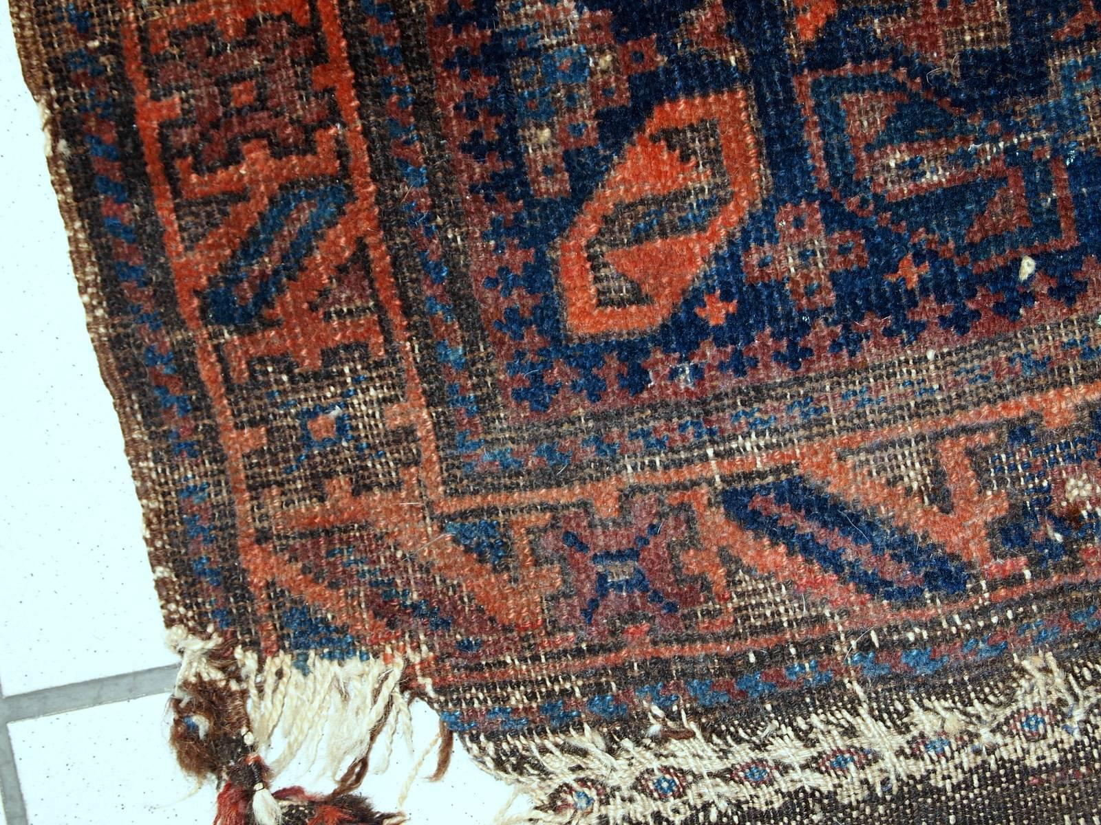 Collectible Afghan Baluch bagface in original condition. The rug has been made in navy blue shade with repeating geometric pattern in red. Very nice tribal border. The bagface is in original condition, has some age wear.
  