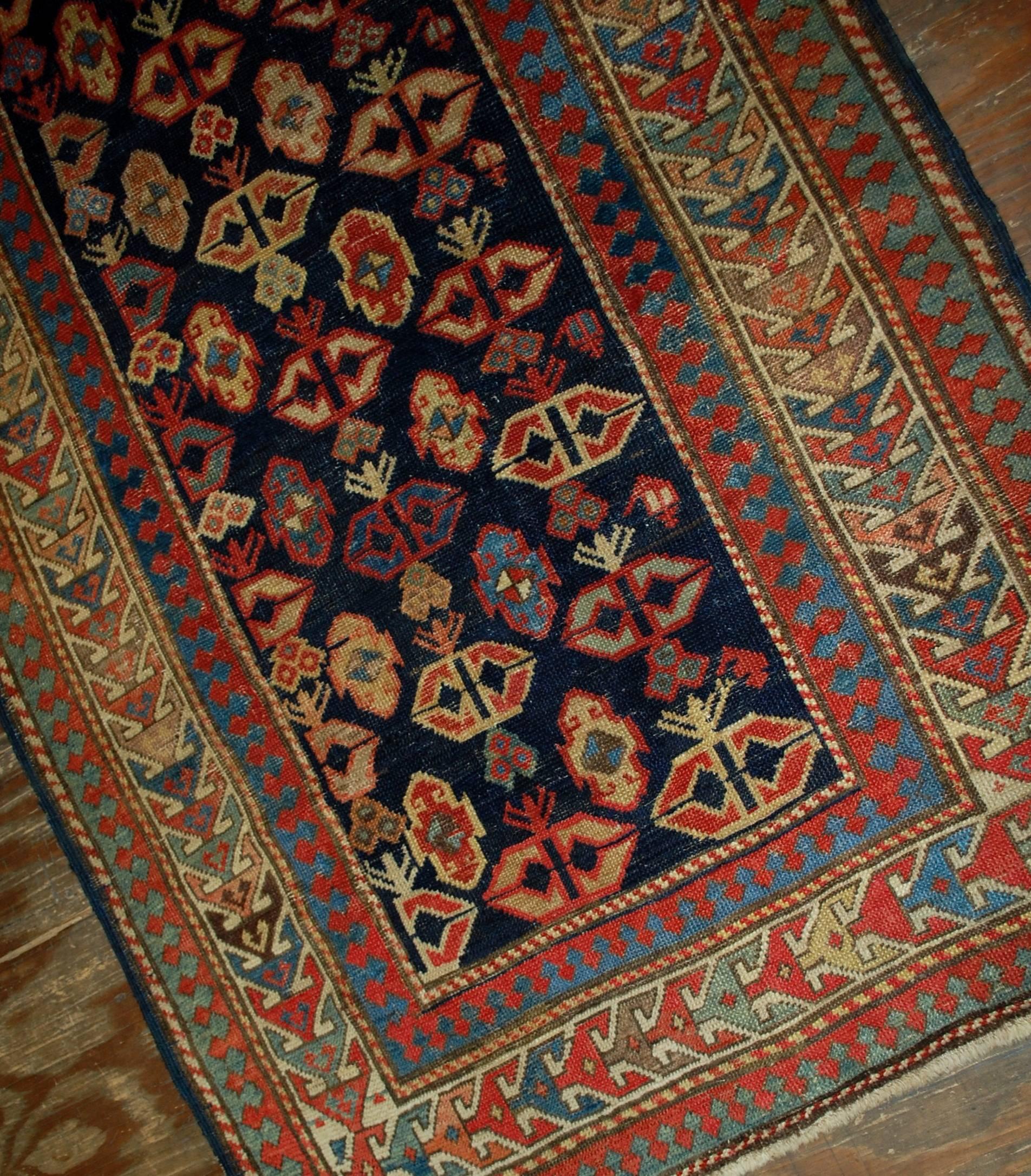 Antique handmade Caucasian Gendje rug in good condition. The rug has dark blue field covered in tribal figures. It is surrounded by the beige border. The rug has been restored and in good condition now.
 
