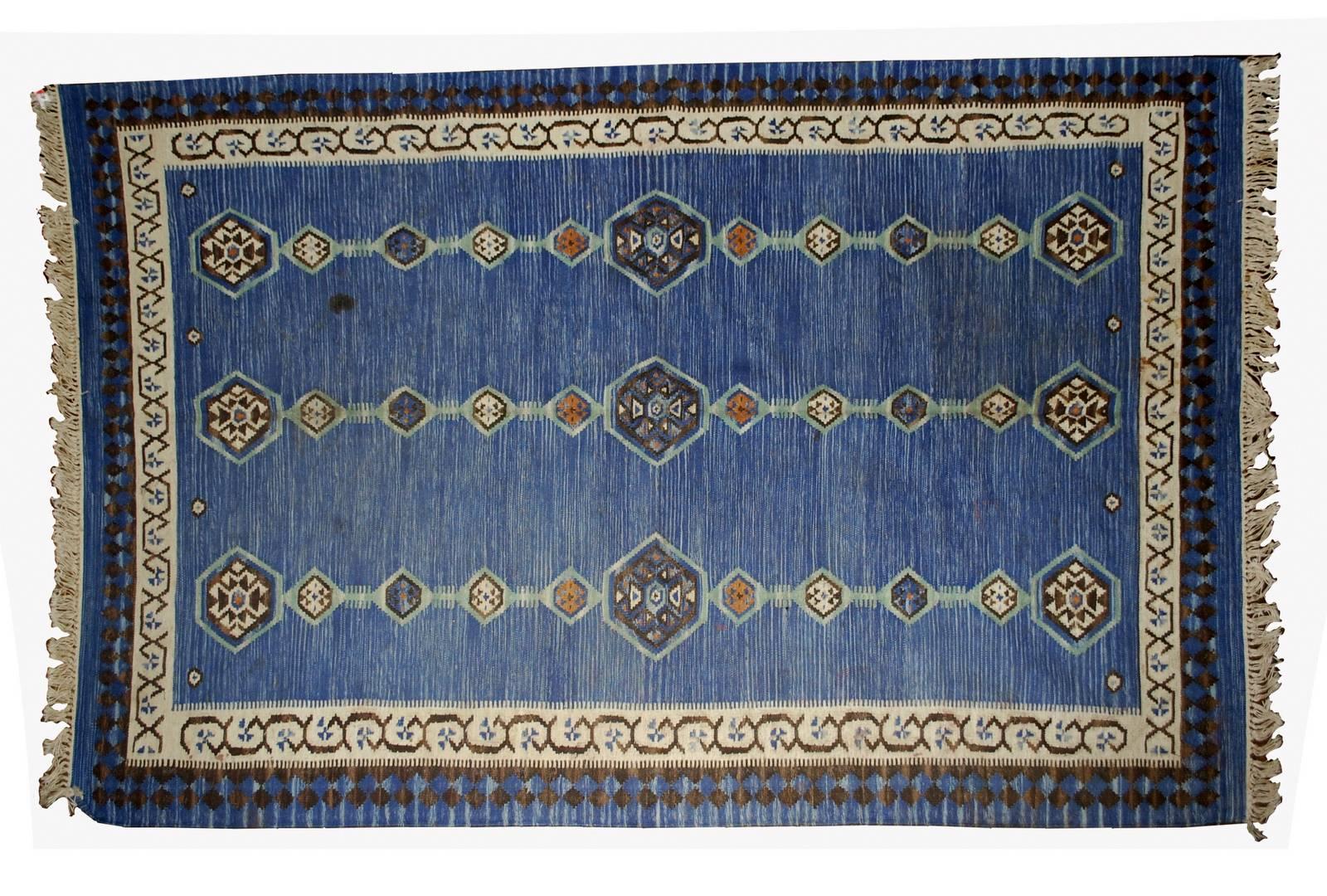 Antique handmade Indian Dhurri Kilim in original condition. This Kilim has very simple tribal motive in lines with decorative border. The rug is in blue shade with beige border. It is in original good condition.
 