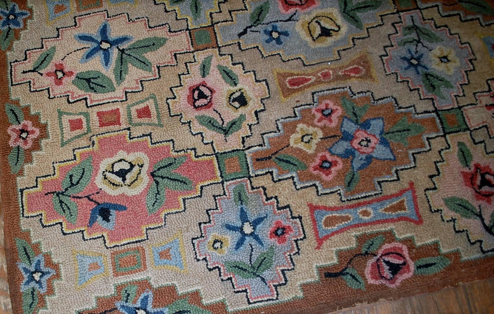 Antique decorative American hooked rug. Beautiful all-over design in mixed geometric and floral design. Beige background decorated with similar diamond shaped geometric figures in different shades. The rug is in original good condition.
 