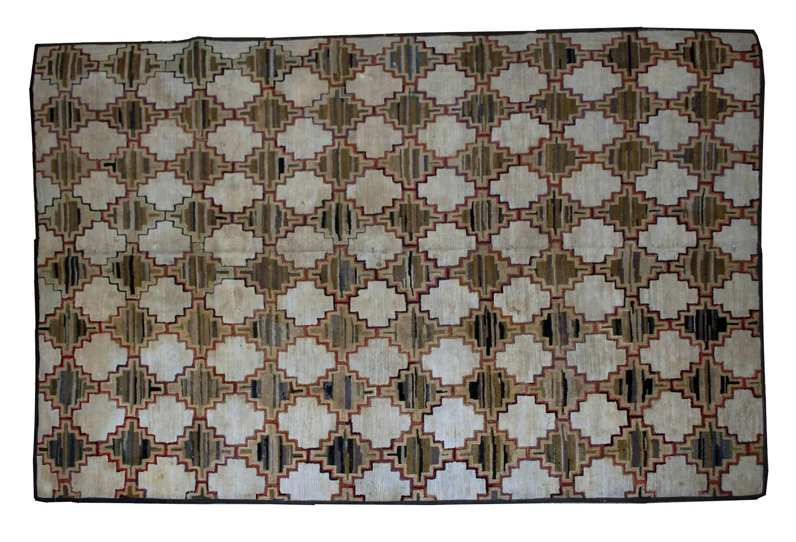 Antique decorative American hooked rug. Beautiful all-over design in repeating geometric pattern- diamond shaped figures in beige and shade of brown with olive green abrashes. The rug has been restored and in good condition now.
 