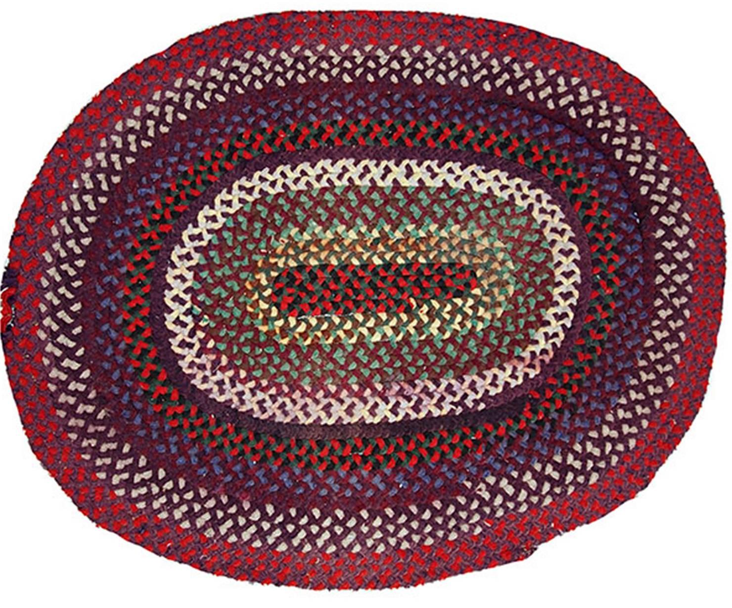 Antique oval American braided rug in deep shades of burgundy, red and purple. It has been made in the beginning of 20th century in USA.
 