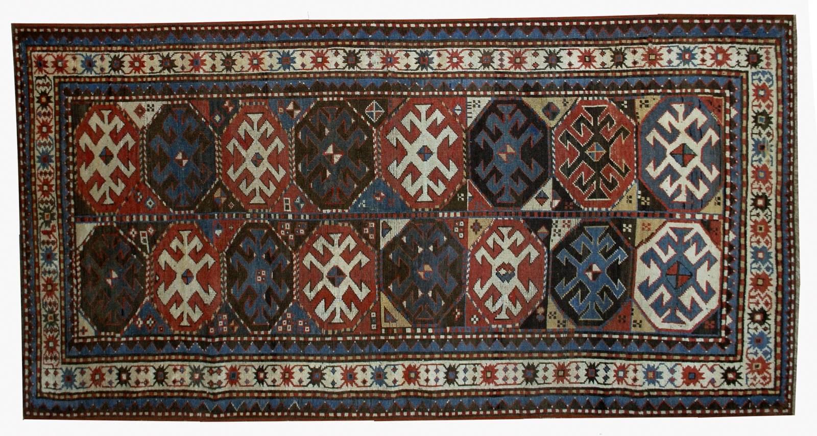 Antique handmade Caucasian Kazak Mohan rug in great condition. This rug has typical Mohan geometric design. Very nice bright shades of red, brown and blue and tribal design. The wool on this type of rugs is very soft which is saying about its