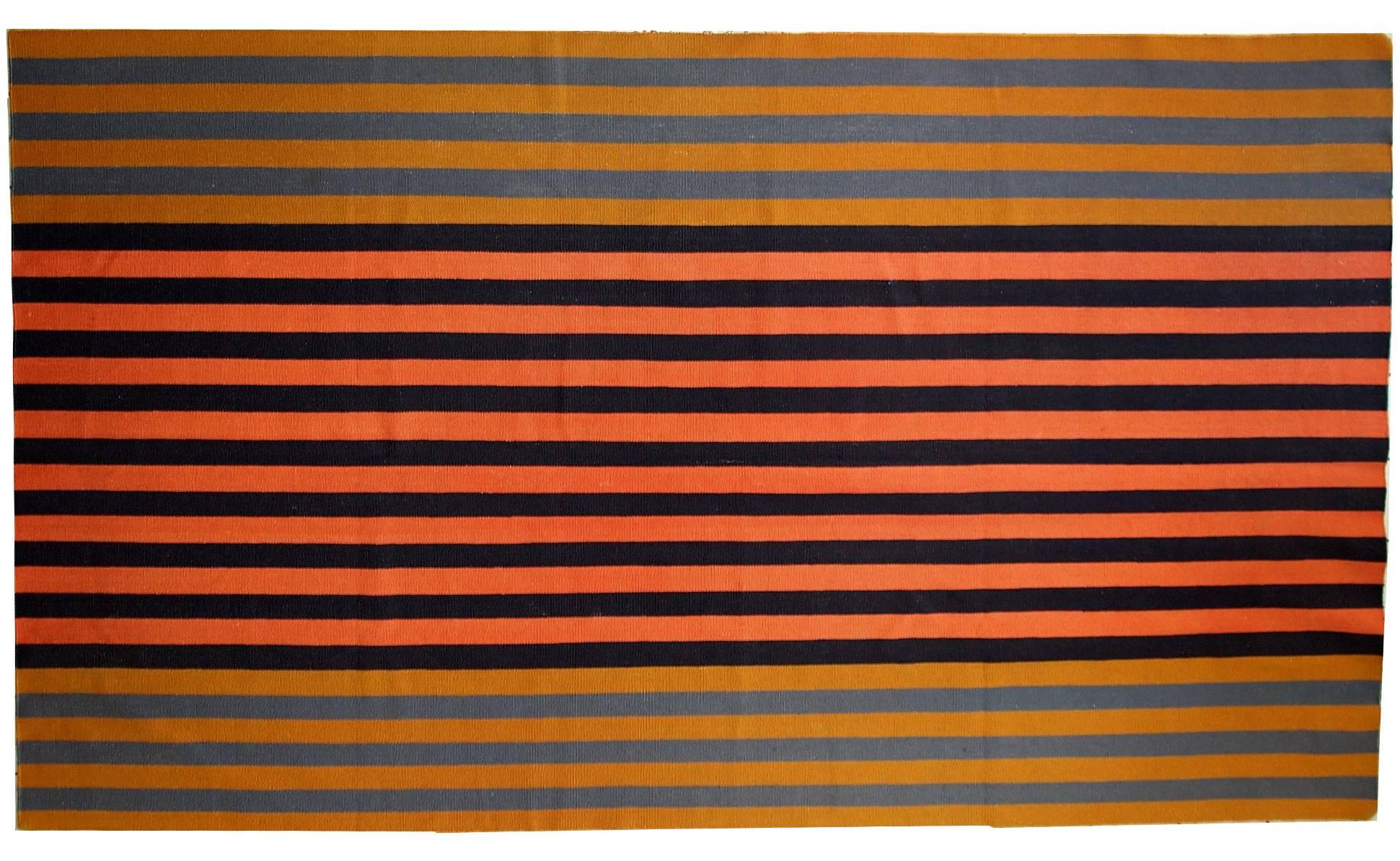 Handmade vintage striped Indian Dhurri kilim in original good condition. This kilim made out of cotton, it is quite heavy. The main shades on it are: black, grey, yellow, peach. Will be a nice attachment to your home.
 