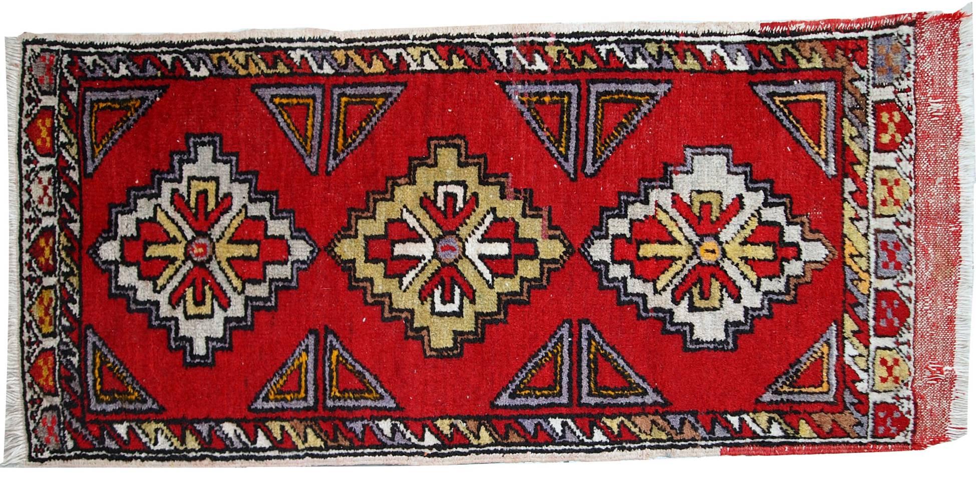 Antique collectible Turkish Yastik rug in original good condition. This rug made out of wool in bright red shade. Geometric accent decorating the rug as well in the shape of diamonds and triangles of white, yellow and purple shades.
   