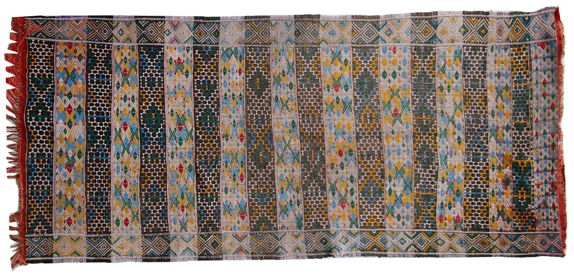This flat-weave made in Tunis, circa 1950s. It is in original condition, has some signs of age. Tribal design and beautiful shades of grey, beige, yellow, sky blue and grass green. The kilim made in cotton.
     