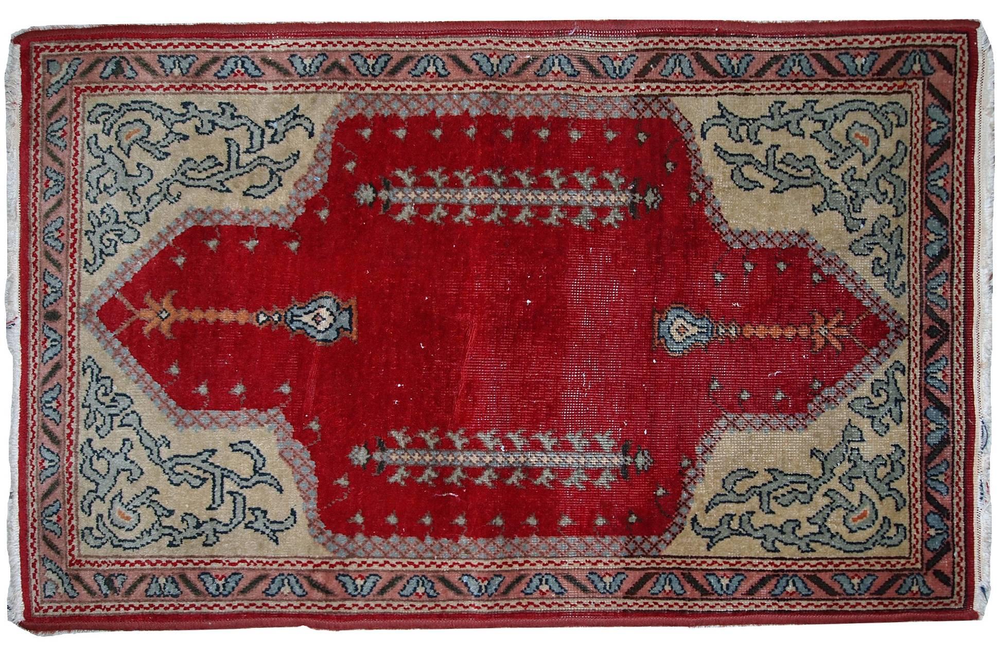 Antique Turkish Konya rug in bright red shade. Yellow corners are decorated in traditional ornaments of azure color. The rug made out of wool. It has some low pile, but generally in original good condition.
 