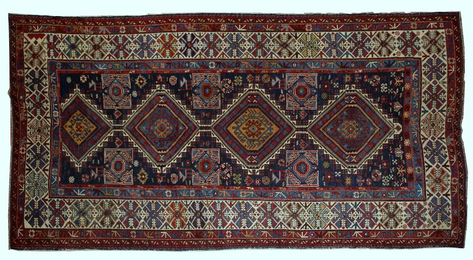 Antique handmade Caucasian Shirvan rug in good condition. This beautiful masterpiece has three diamond-shaped medallions in the centre with fourth made in half. Night blue background covered randomly in tribal ornaments. The border decorated in