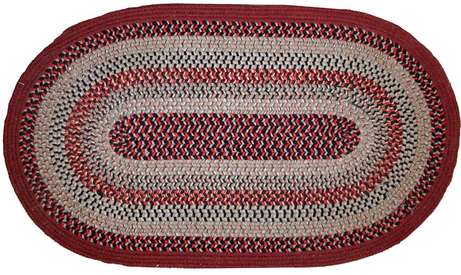 Handmade antique American braided rug in original good condition. The rug made in red, grey, burgundy and black shades. It is thick and strong.