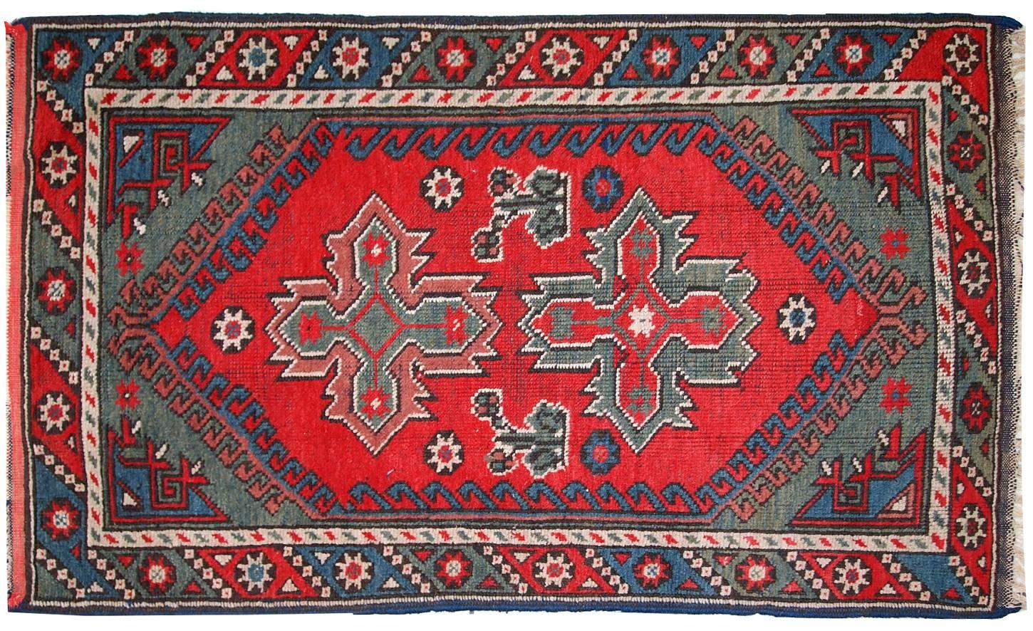 Turkish Anatolian antique handmade rug in bright red and green shades. Very beautiful tribal design. The rug is in original good condition, it has some low pile areas.
 