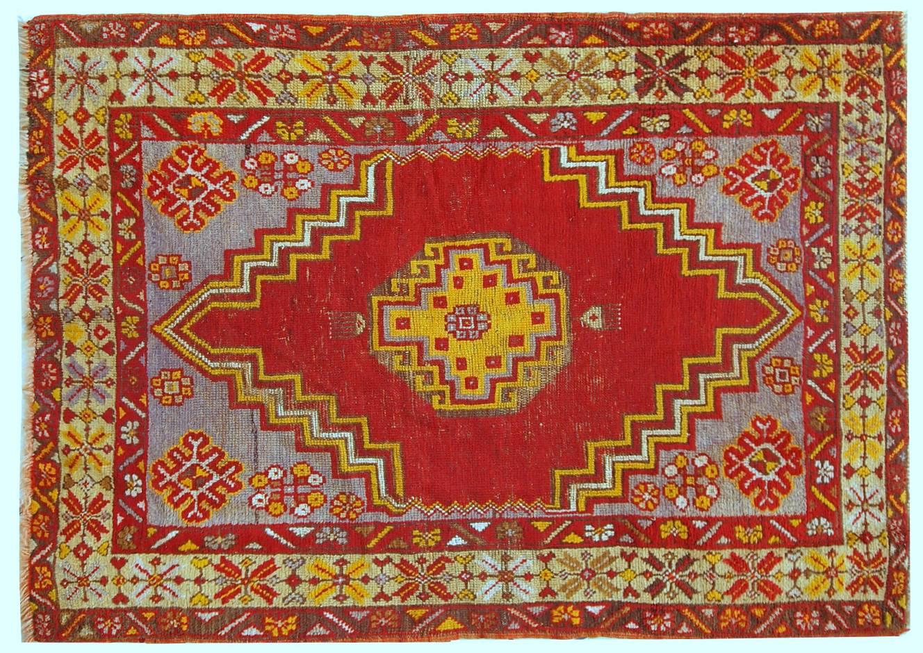 Turkish Anatolian rug in original condition, it has some little age wear. The rug made in bright shades of red, yellow and purple. Very soft wool.
 